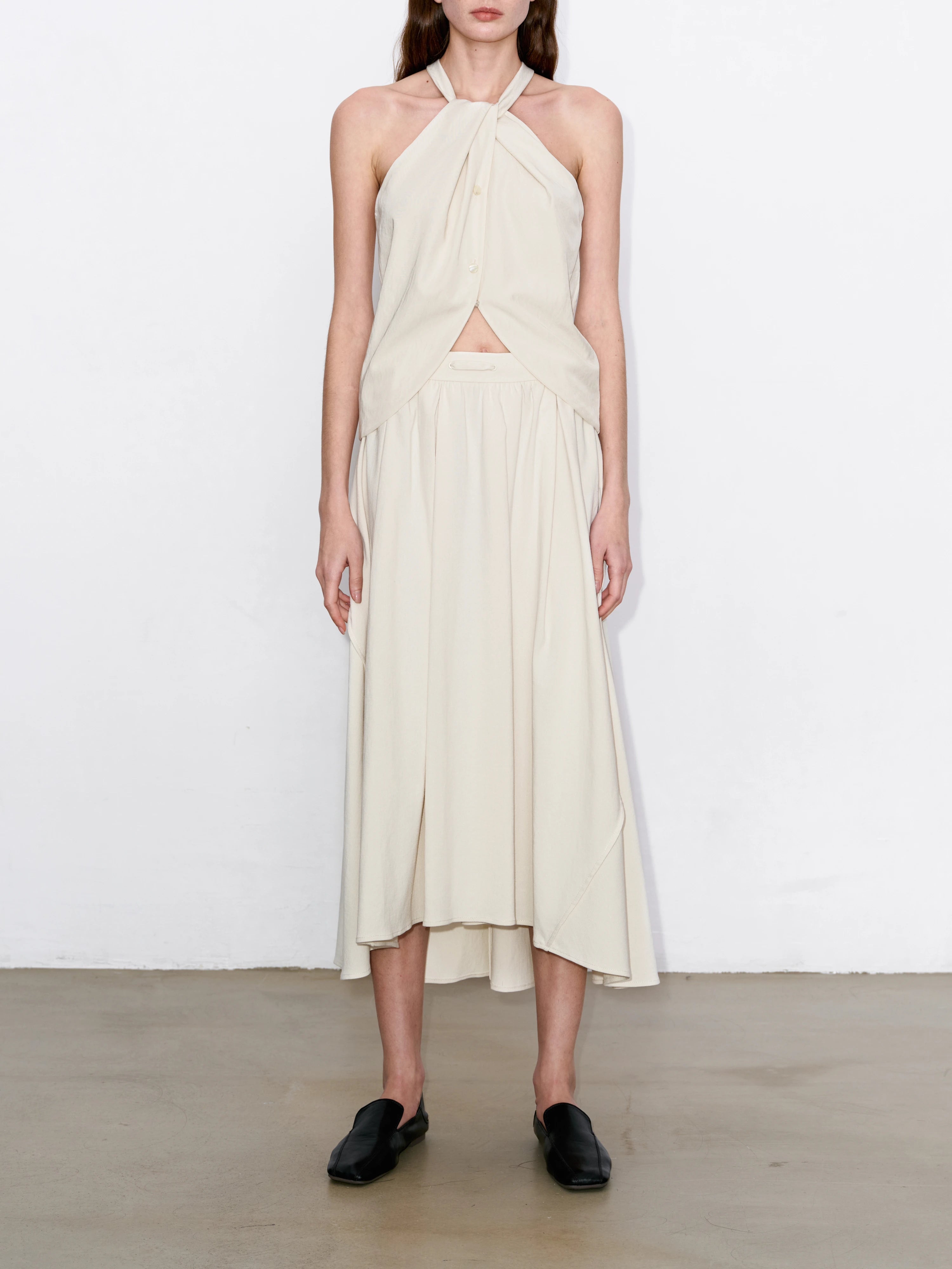 Cotton-linen skirt full look with asymmetric hem, breathable texture, versatile for refined or casual outfits.