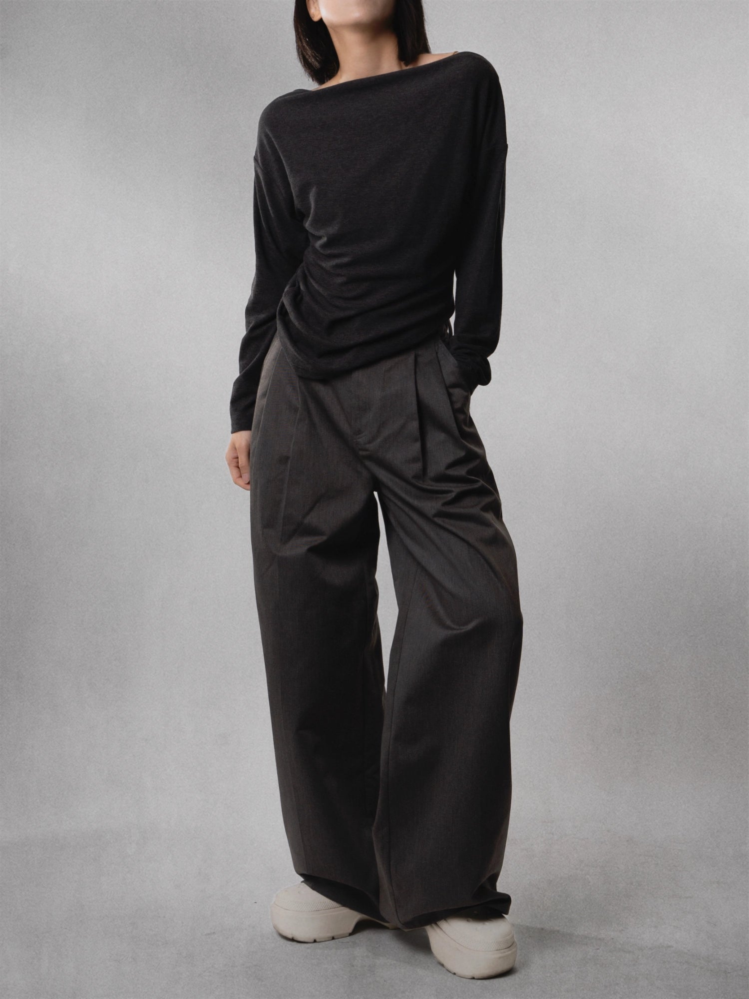 Front full-body view of charcoal drape wide-leg trousers, showing high-rise waist and relaxed flowing silhouette.