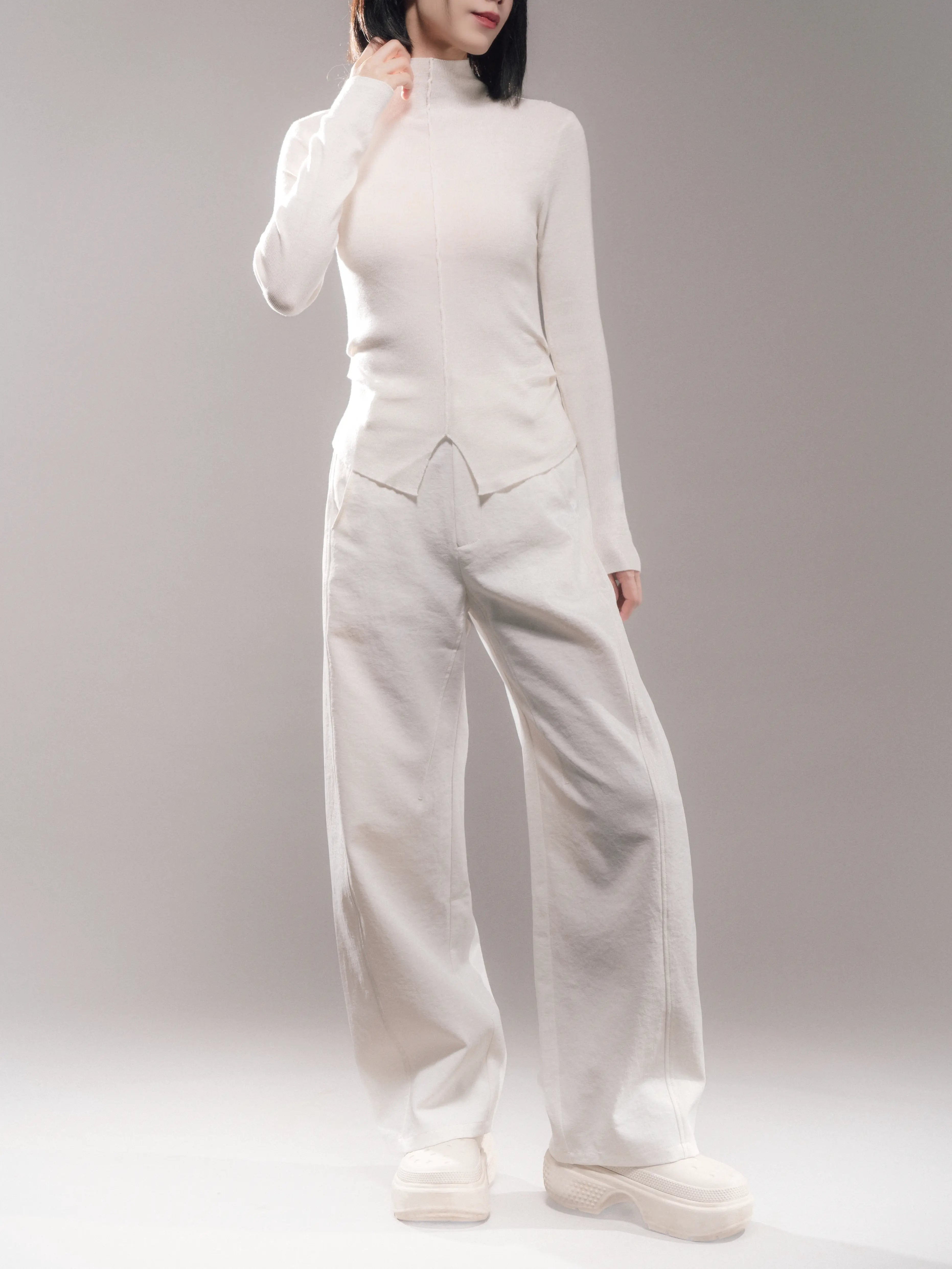 Model wearing white Early Spring Wool Top, soft wool-cashmere blend, slim fit with clean neckline and relaxed silhouette, minimal spring outfit full body.