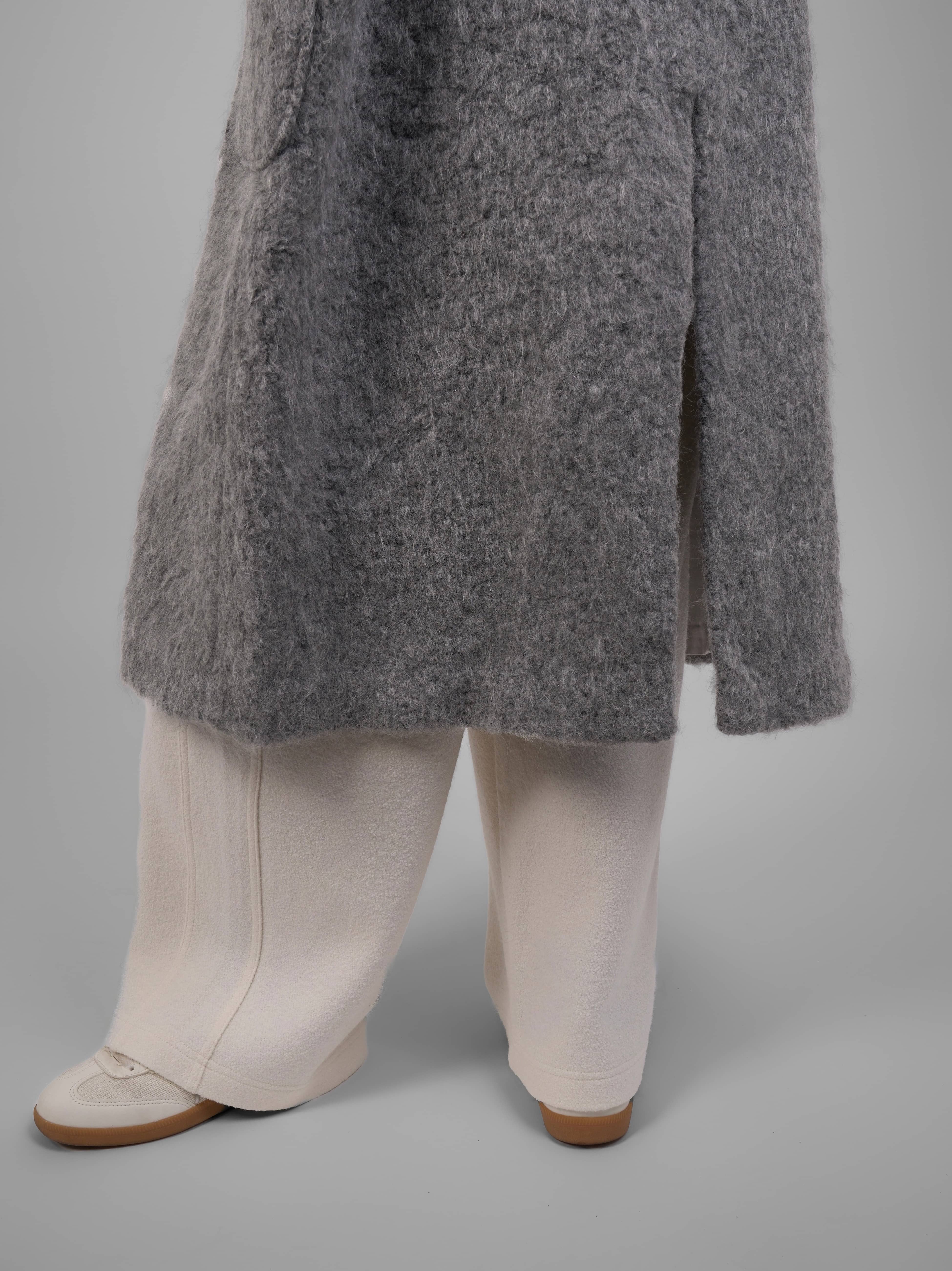 Detail shot of XXLSMILE Grey Wool Toggle Coat cuff and side slit craftsmanship.