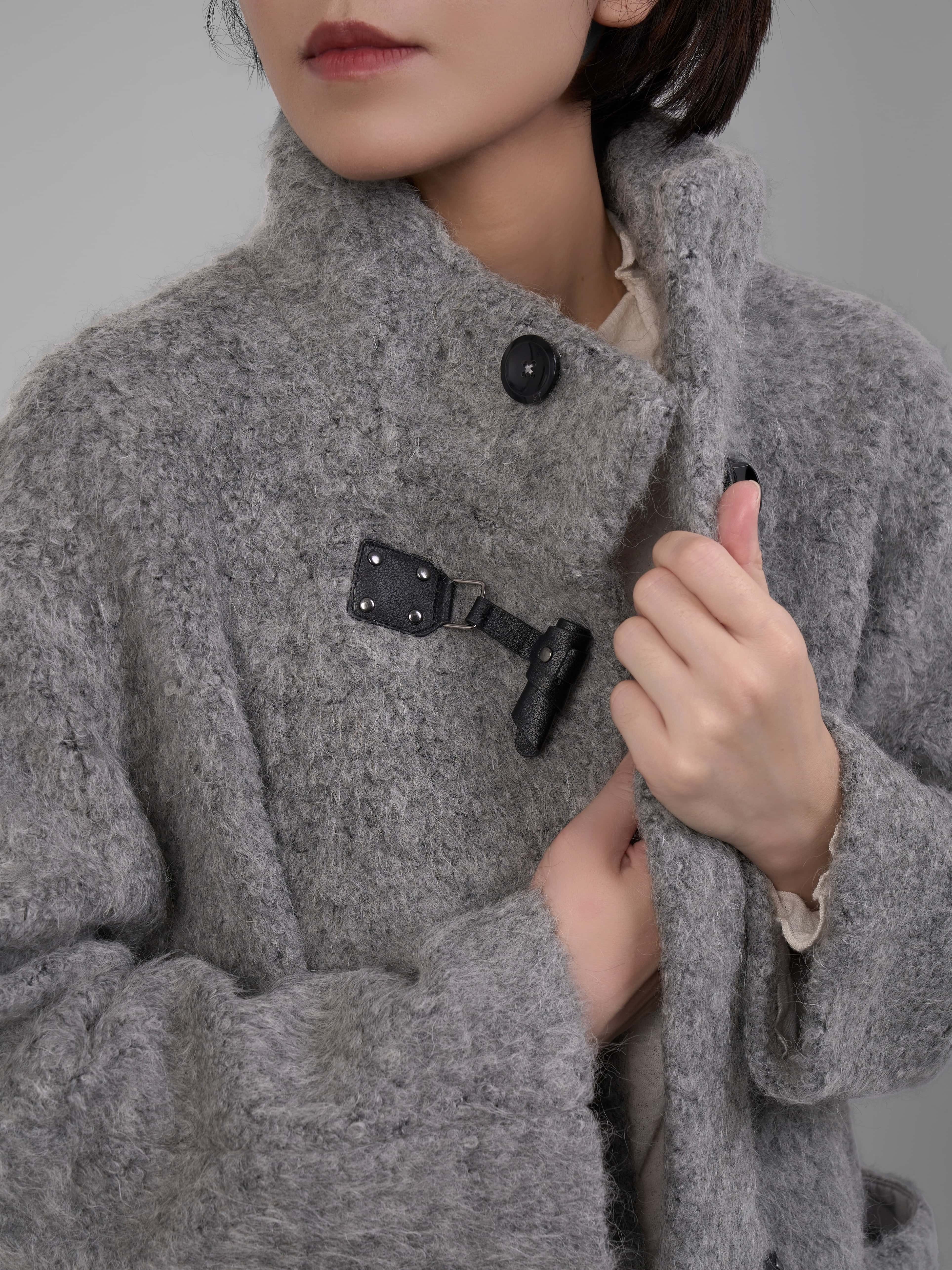 Close-up toggle fastening detail on XXLSMILE Grey Wool Toggle Coat.
