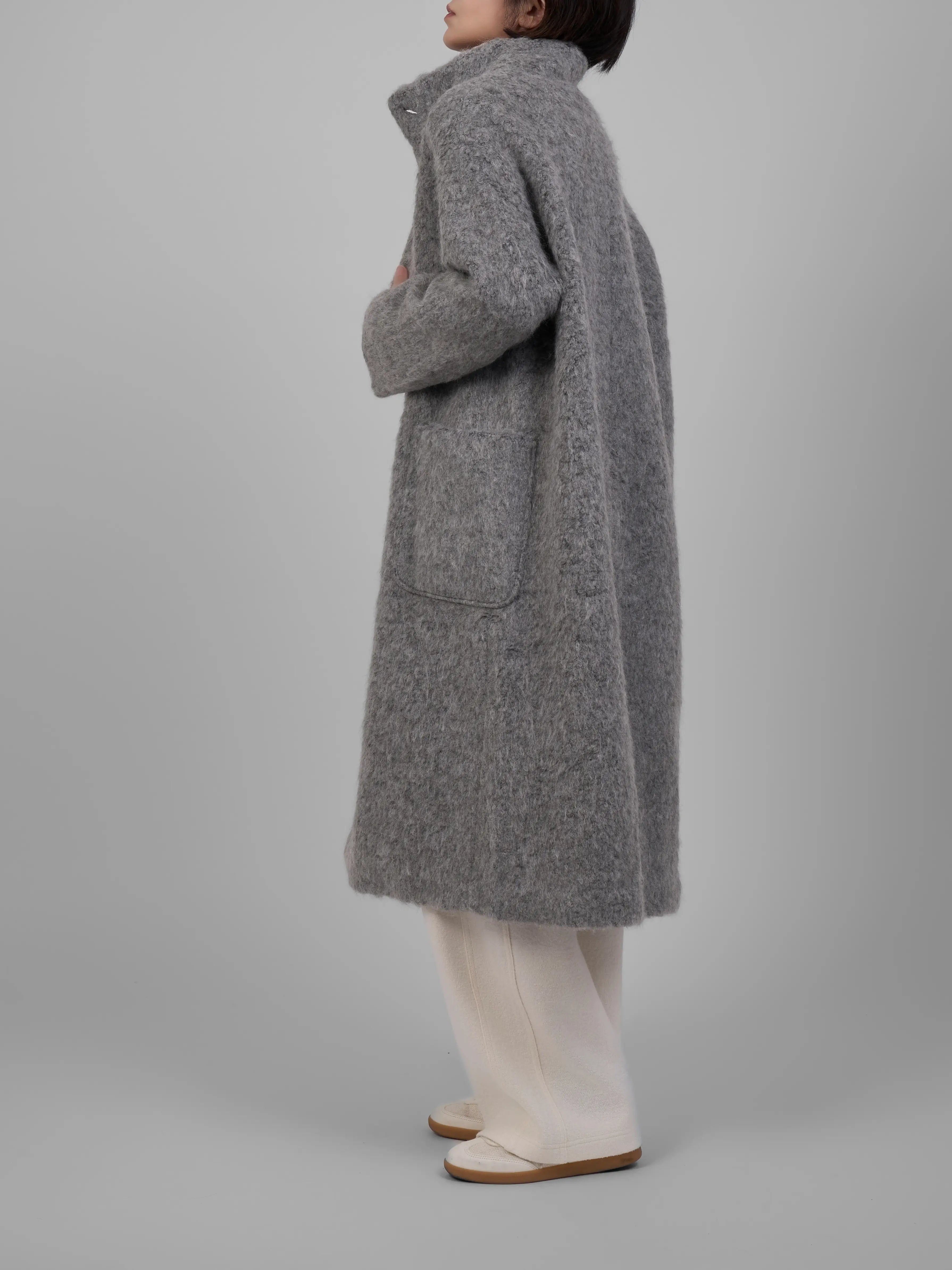 Minimalist side profile of XXLSMILE Grey Wool Toggle Coat emphasizing premium wool fabric.