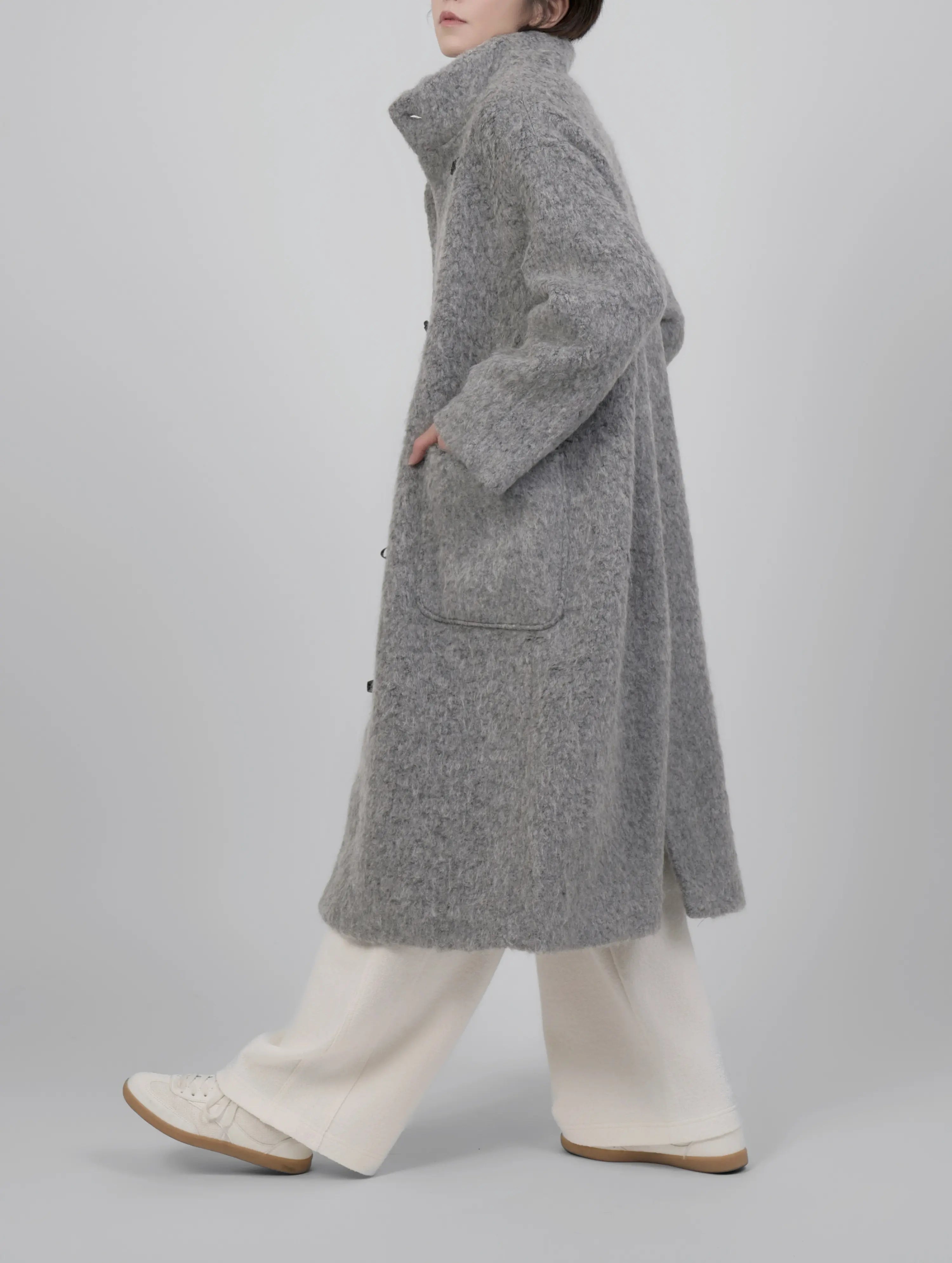 Side walking view capturing movement and natural flow of the fabric.