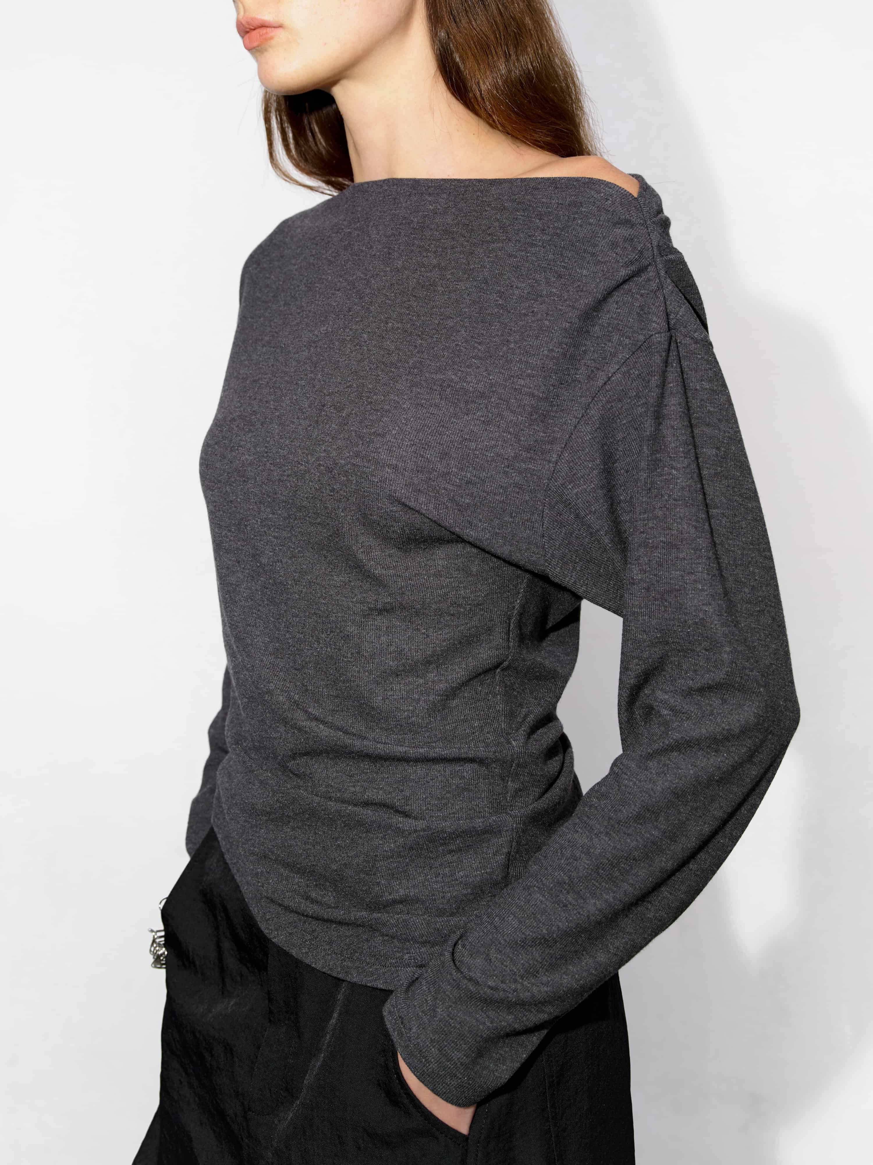 Close-up of asymmetric collar detail on grey Tencel-wool top, long sleeves, natural body-fit drape for fabric detail presentation.