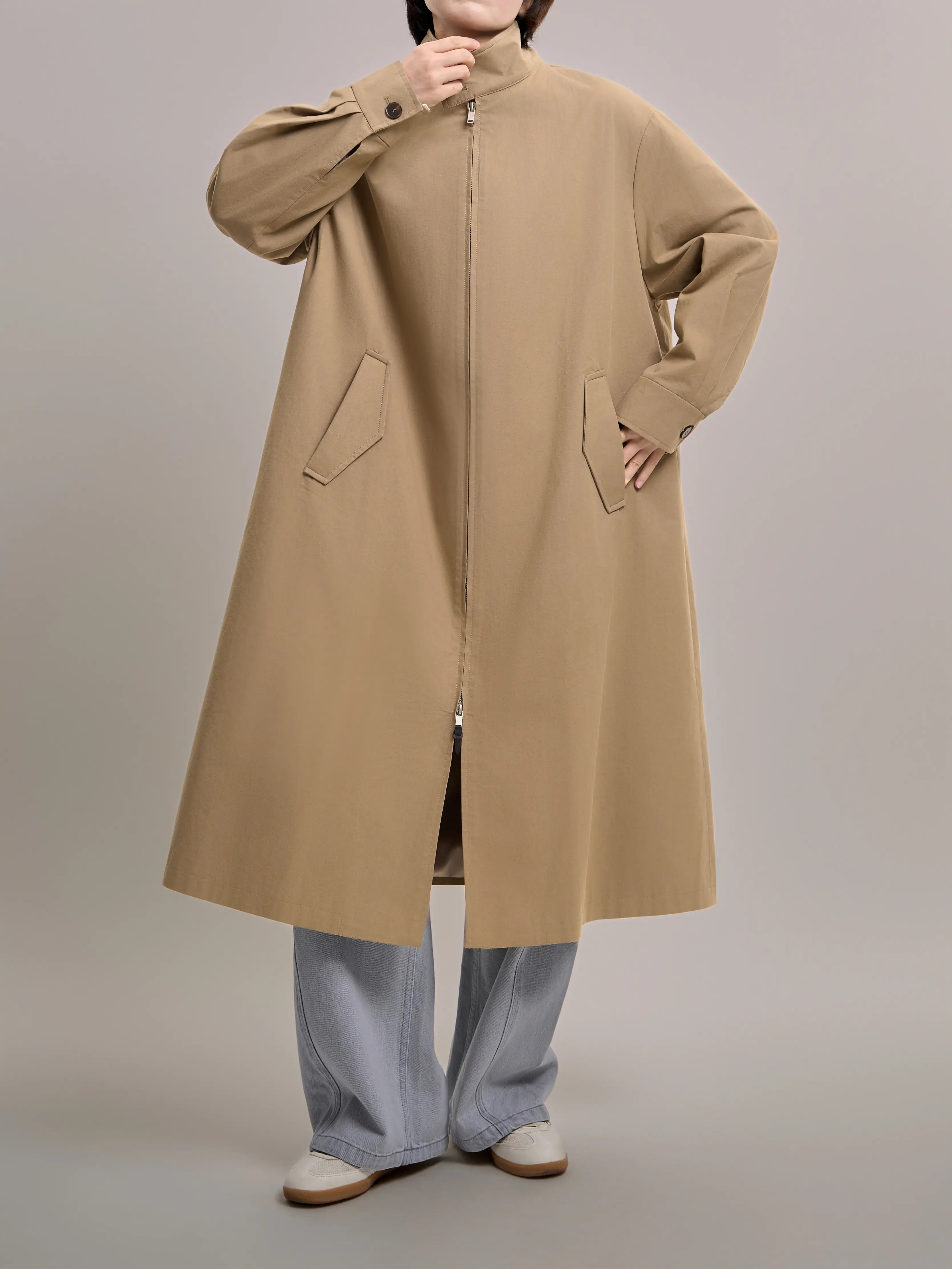 Front detail of khaki trench coat with a relaxed fit, styled for a modern minimalist everyday outfit.