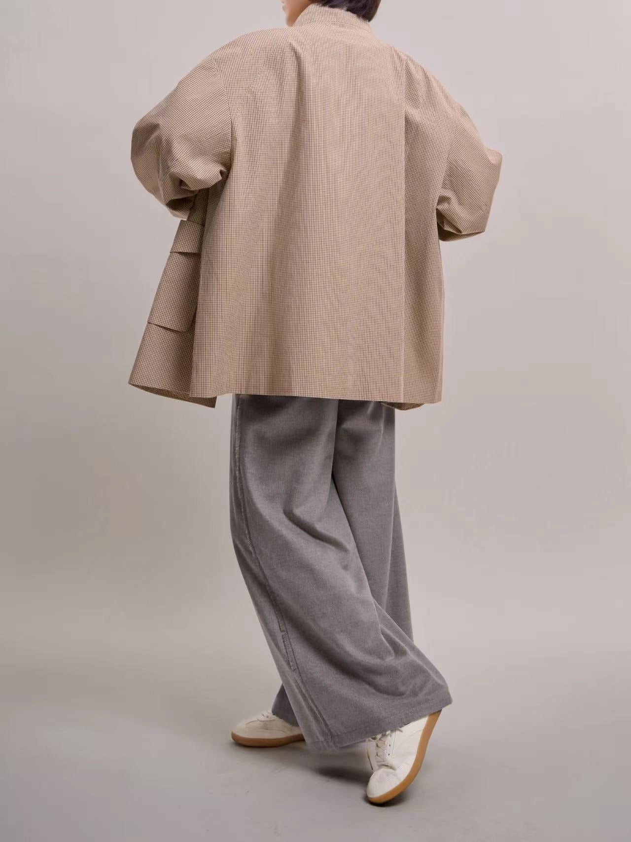 Back view of beige minimal check jacket, showing clean seams and relaxed cotton drape.