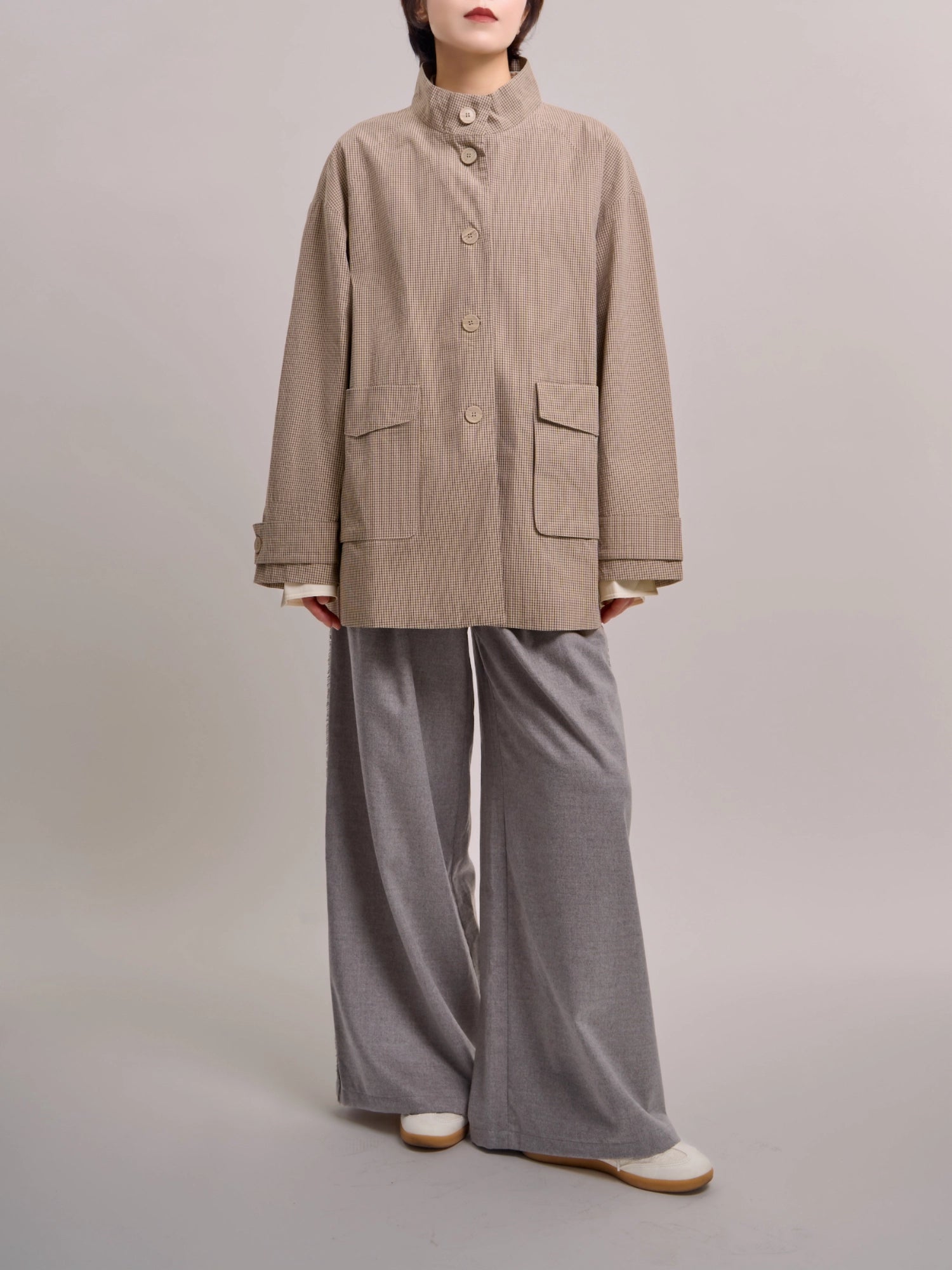 Front view of beige minimal check jacket showing fine-check cotton texture and clean minimal construction.