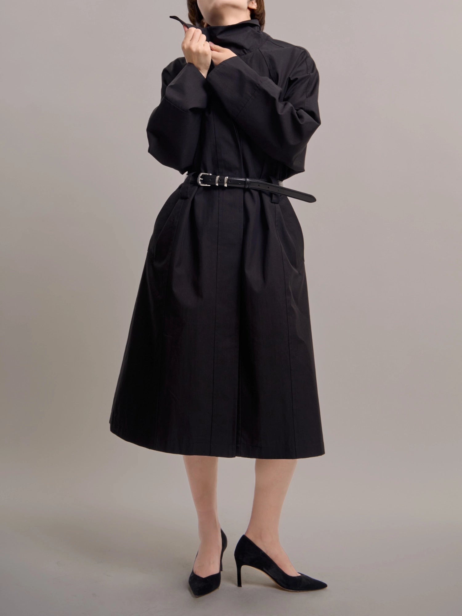 Full-length front view of black Noir Trench with belt, highlighting crisp cotton–nylon texture.