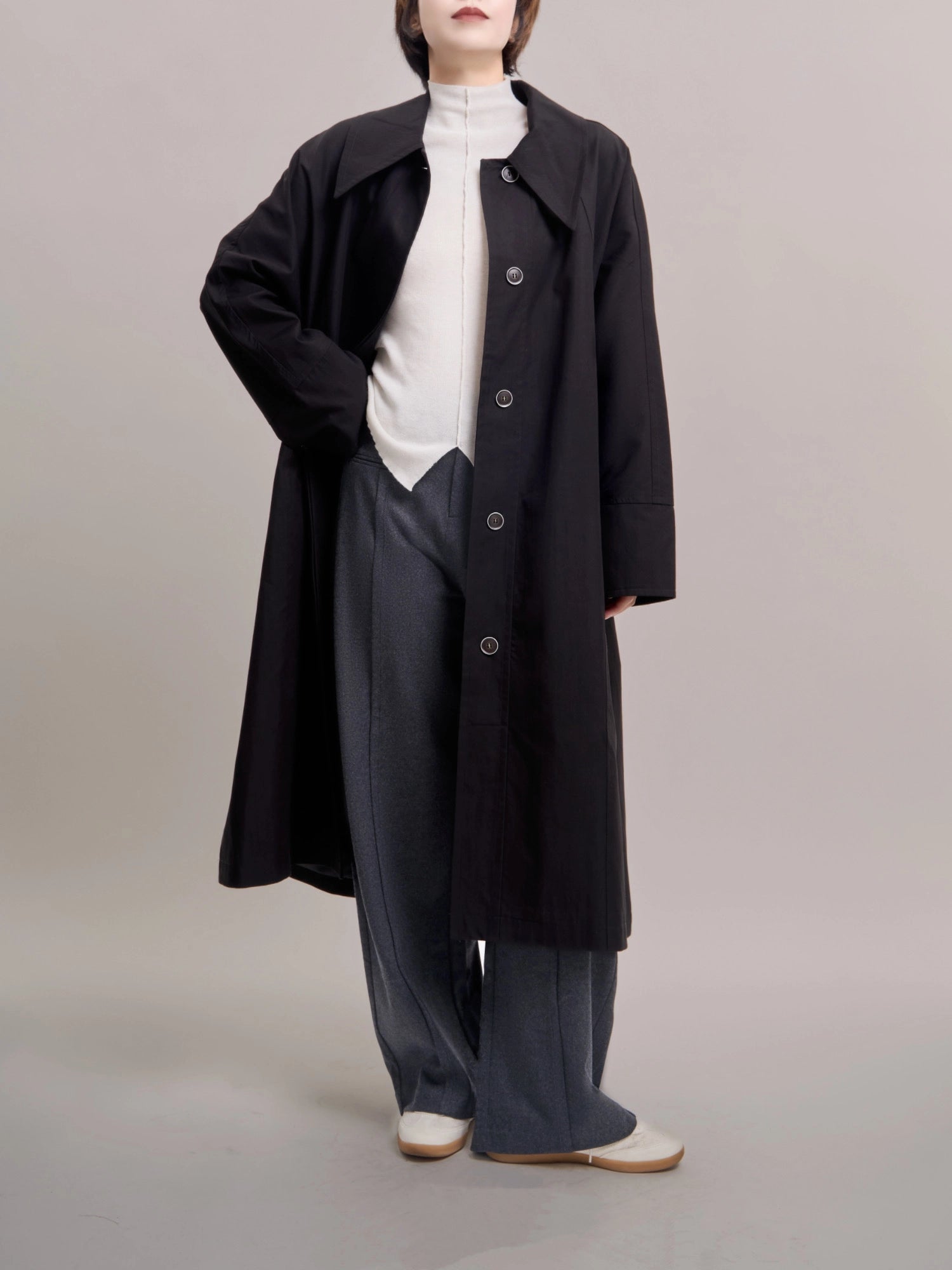 Black Noir Trench styled with shirt and trousers, highlighting clean layering silhouette.