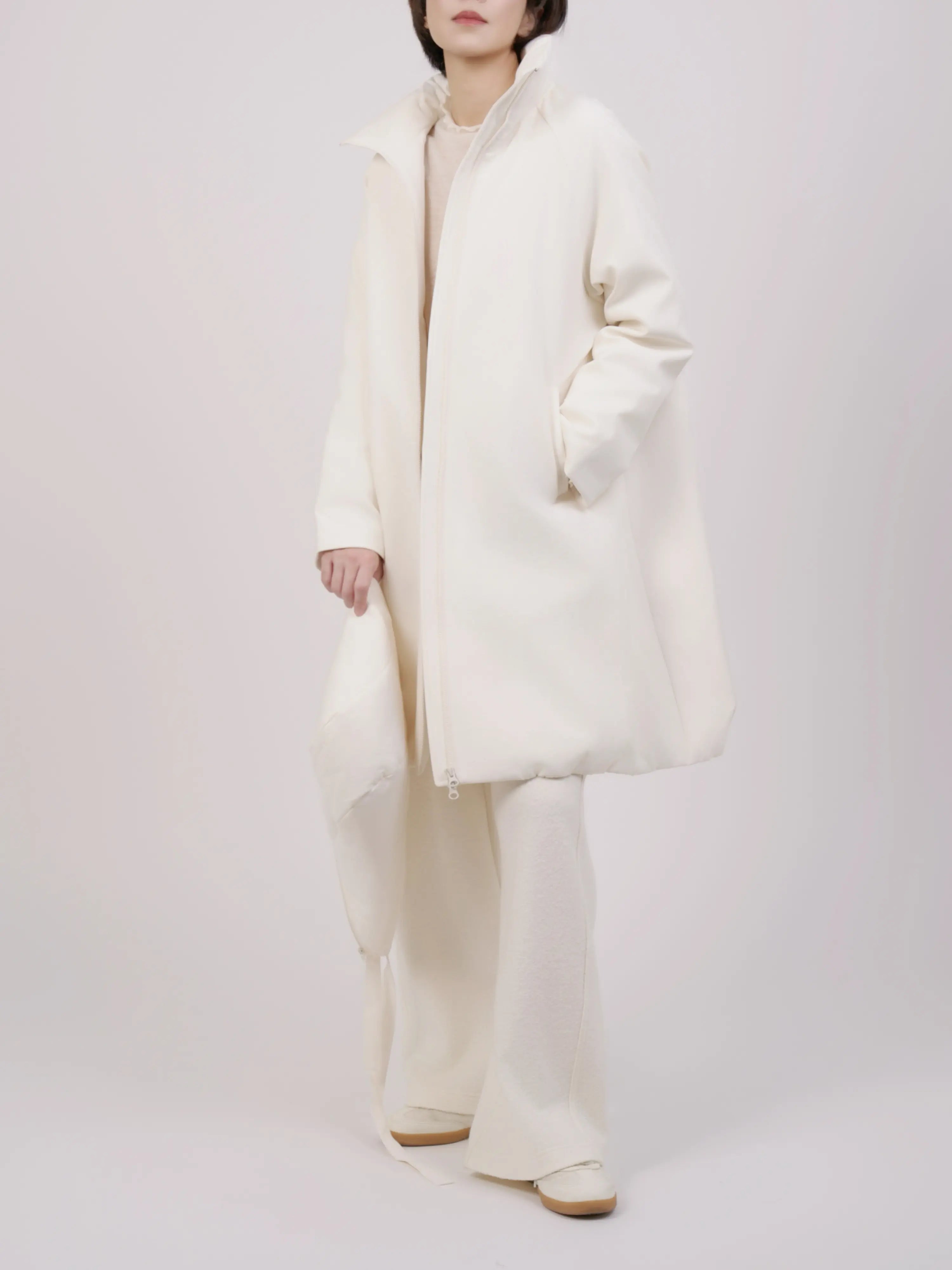 Full body look of hooded down coat with relaxed fit and soft winter layering.