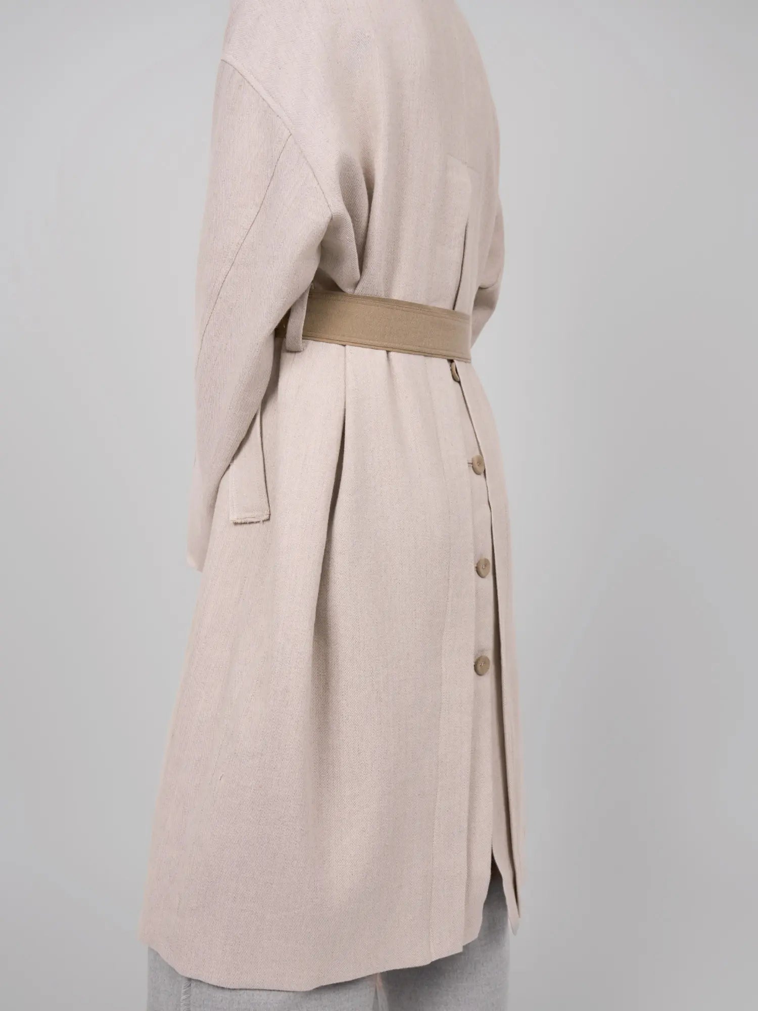 Back detail with belt placement and soft flowing silhouette.