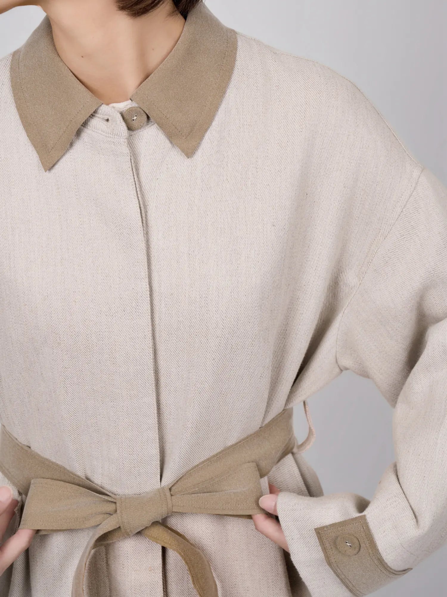 Close-up of collar and neckline with subtle texture and refined finish.