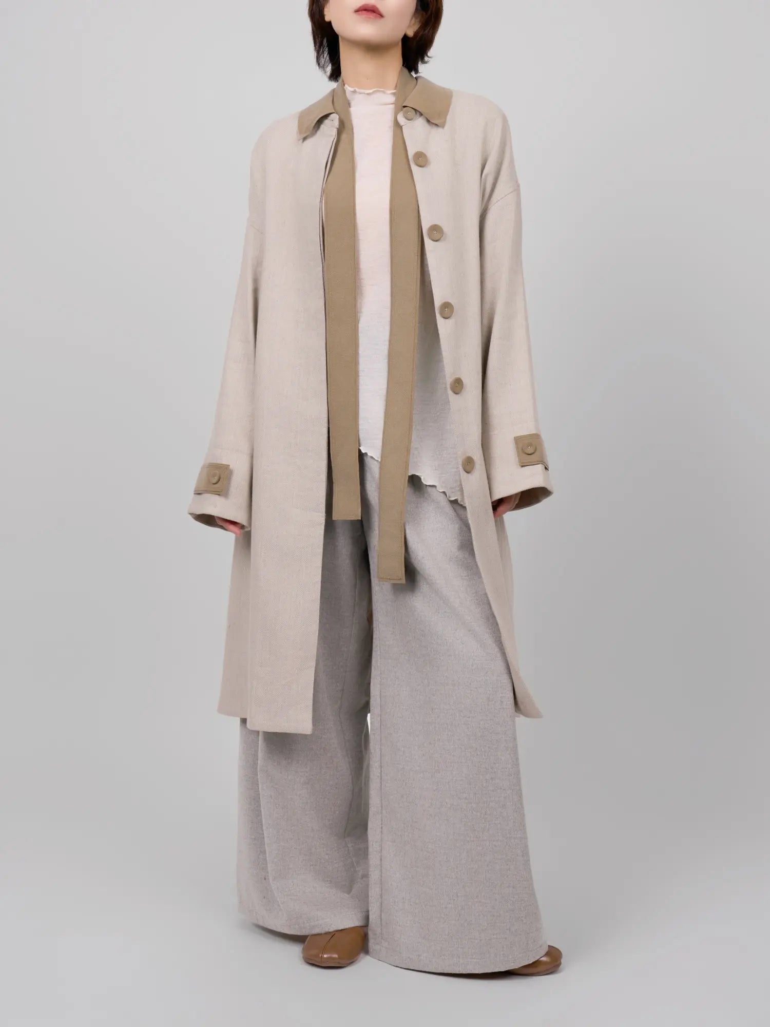 Full body look of rain dew linen-wool coat styled with wide-leg trousers, showing a soft layered silhouette.