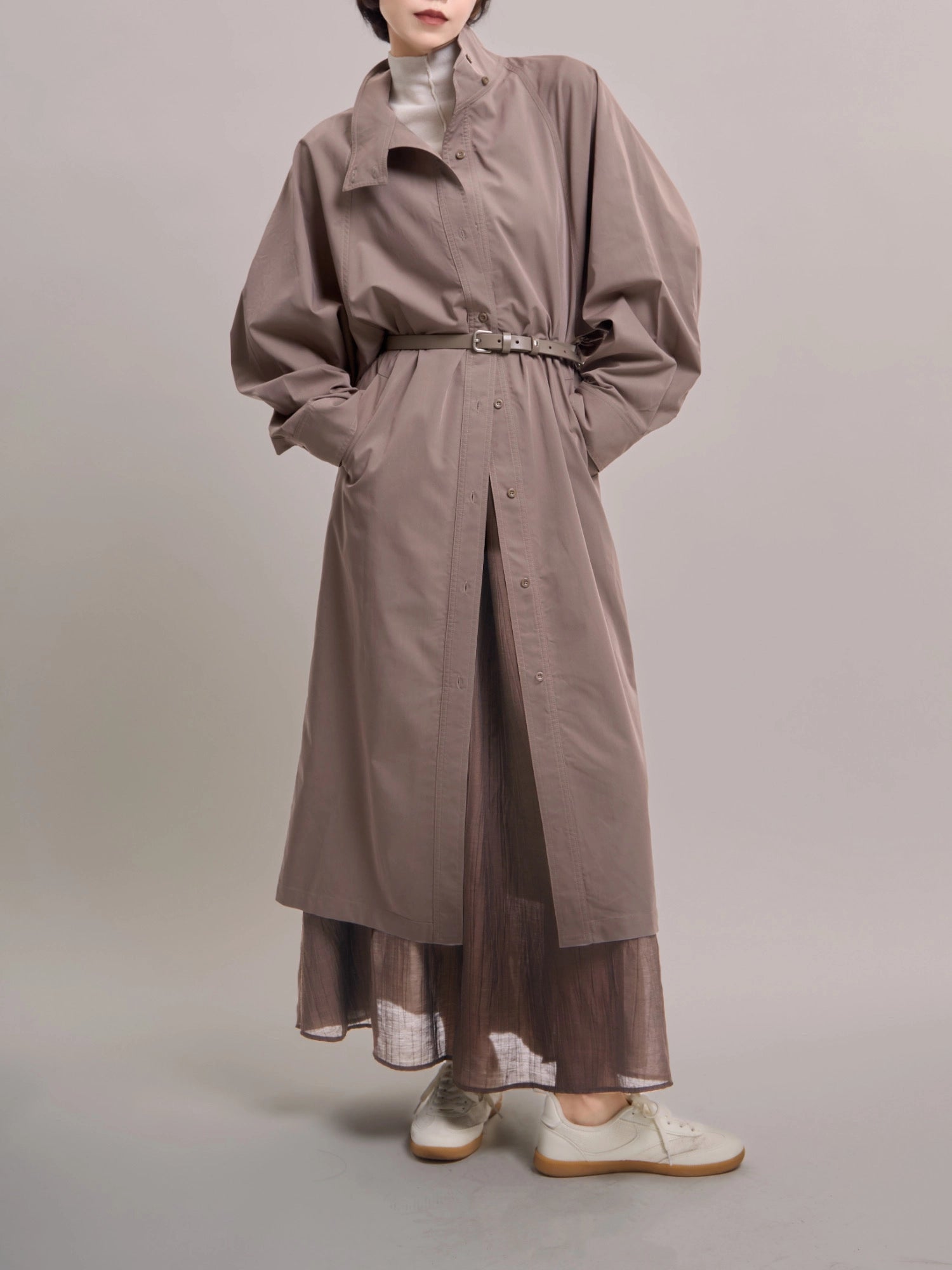 Full-body front view of taupe Ripple Trench, showing belted waist and clean structured silhouette.