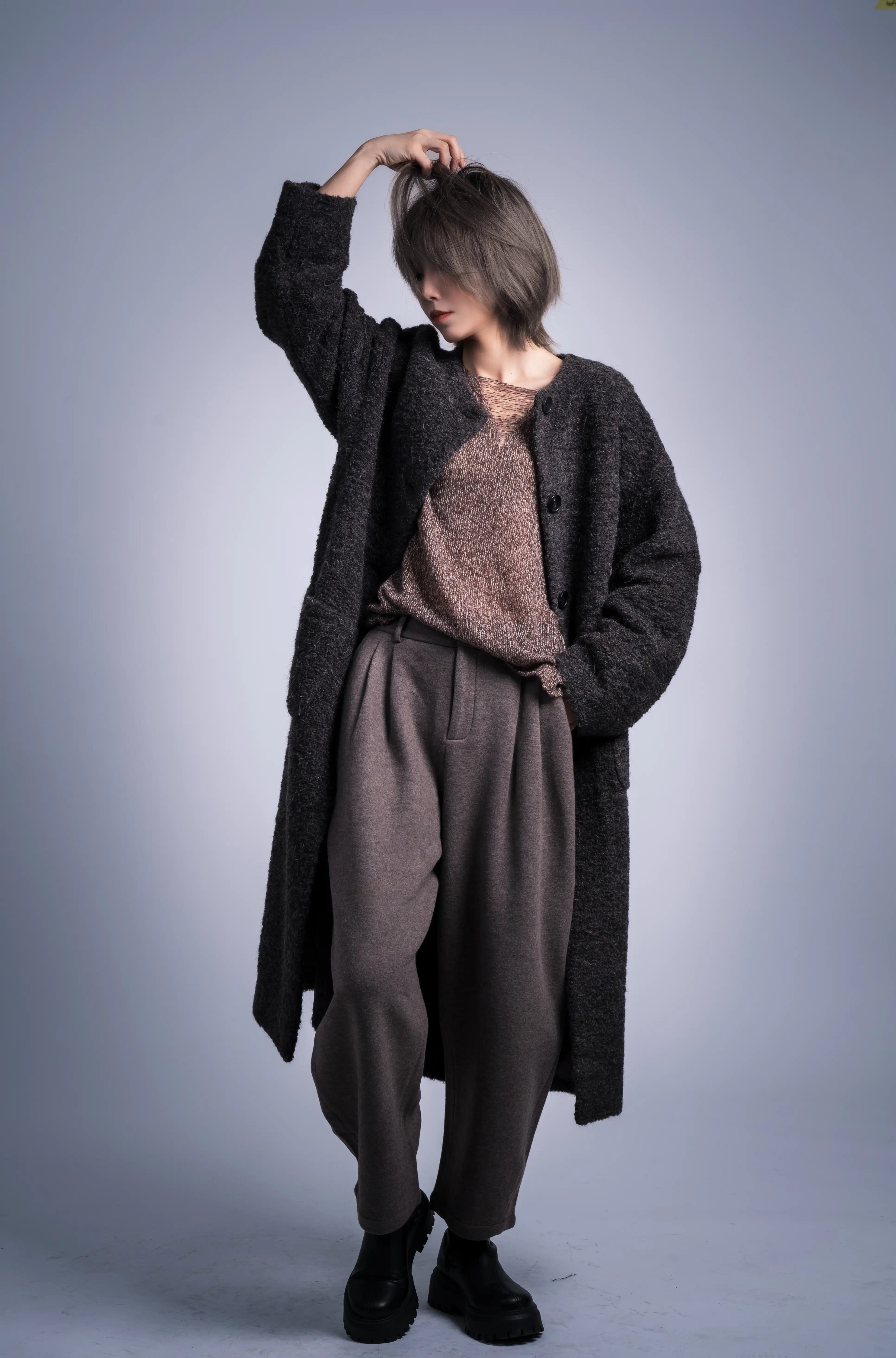 Front view full body of charcoal alpaca wool coat, relaxed cut, modern collarless shape, layered winter outfit.