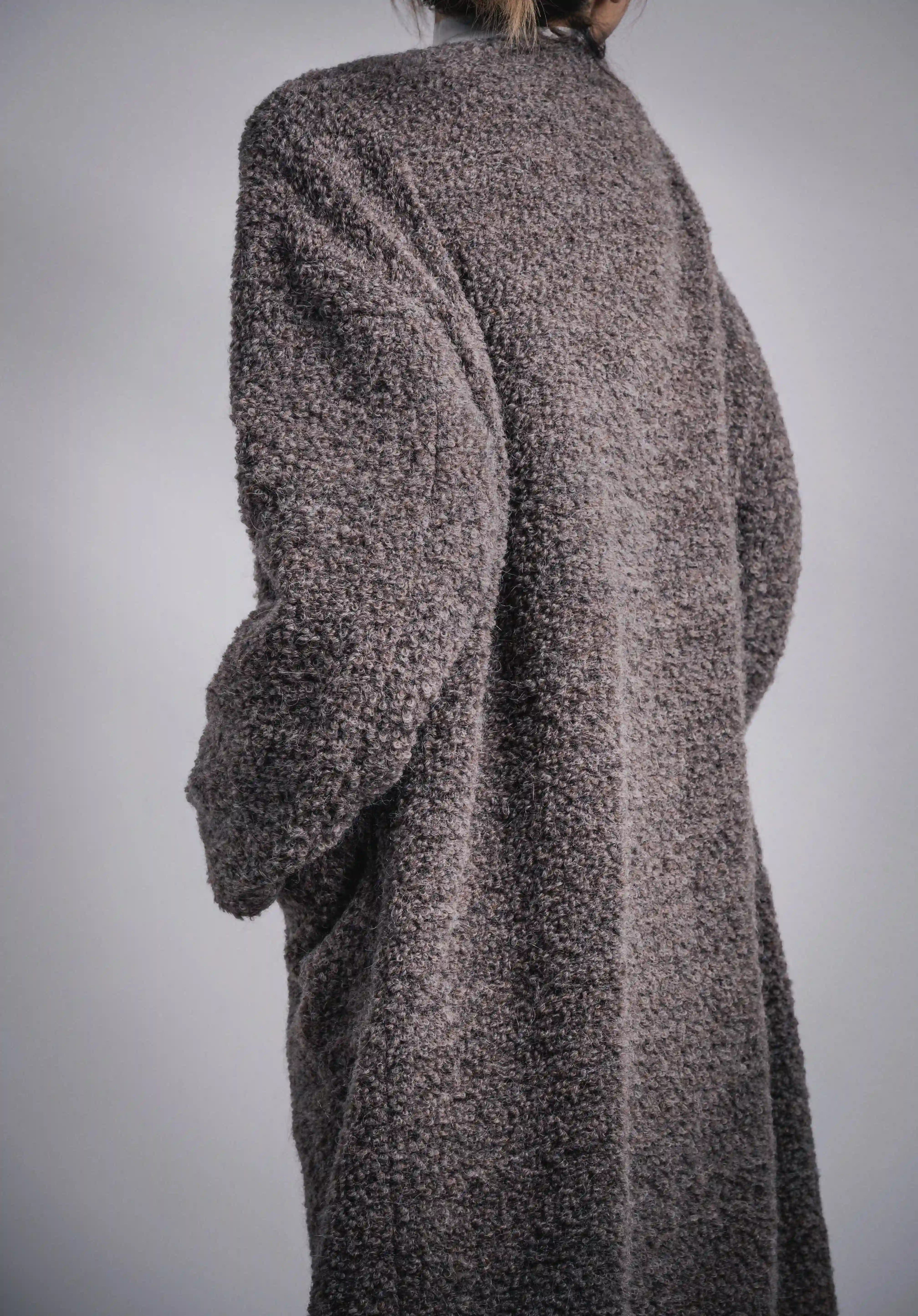 Back shoulder angle of grey Snowy Grace wool coat, soft alpaca texture, long cocoon line.