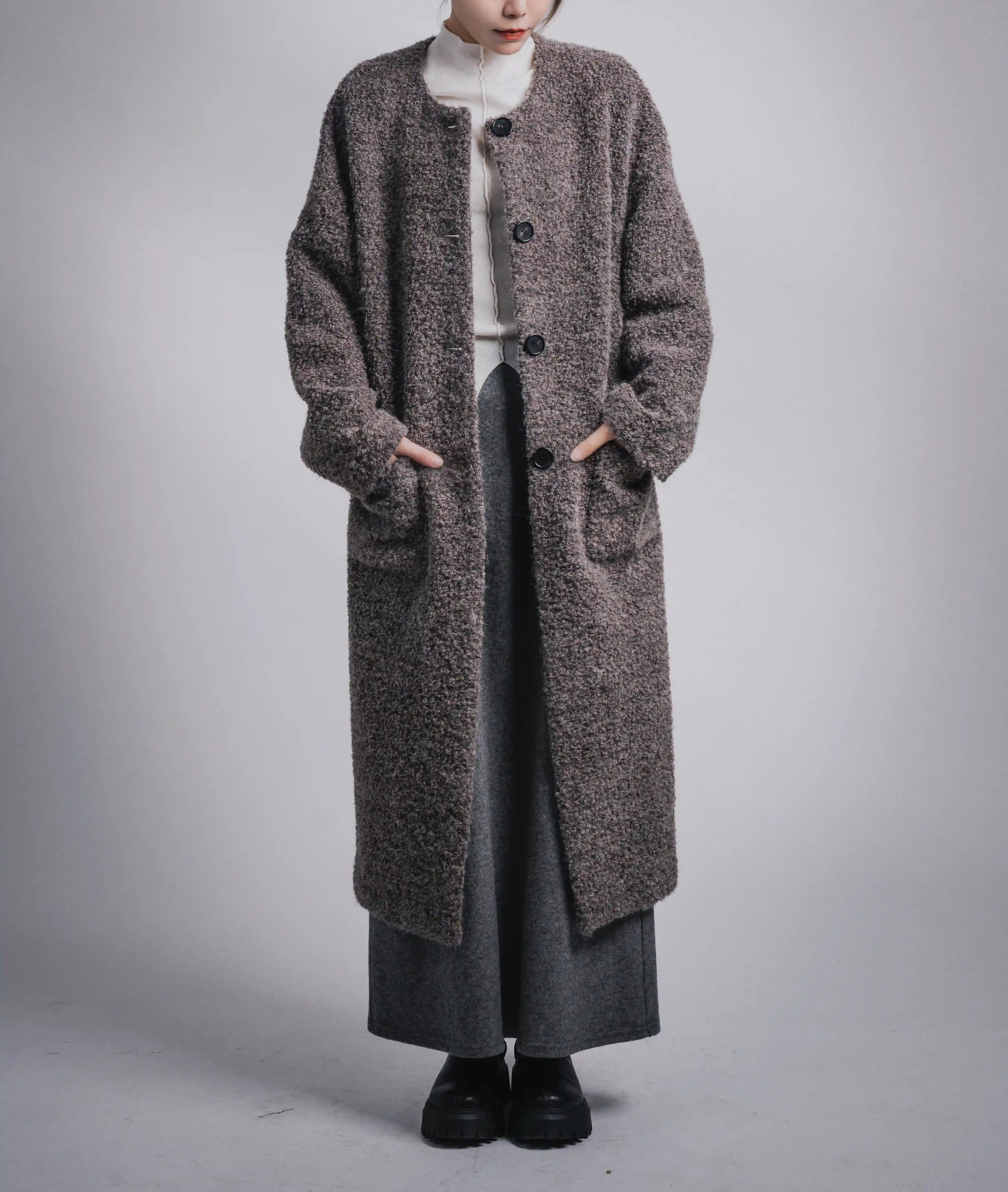 Grey alpaca wool long coat full-body front view, collarless design, winter styling with knit layer, relaxed silhouette.
