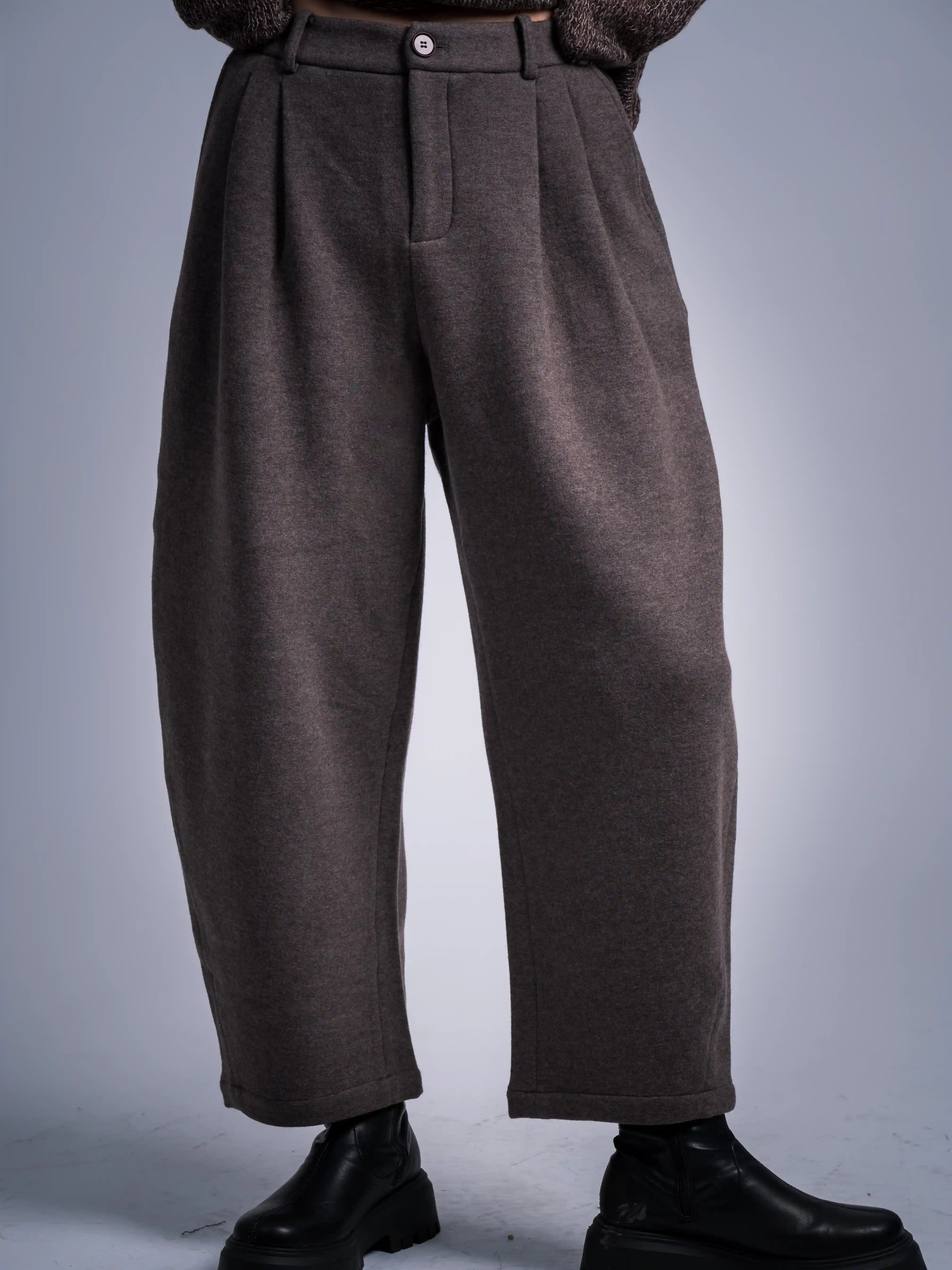 Grey wool trousers front styling, cropped relaxed cut, paired with boots, refined everyday outfit.
