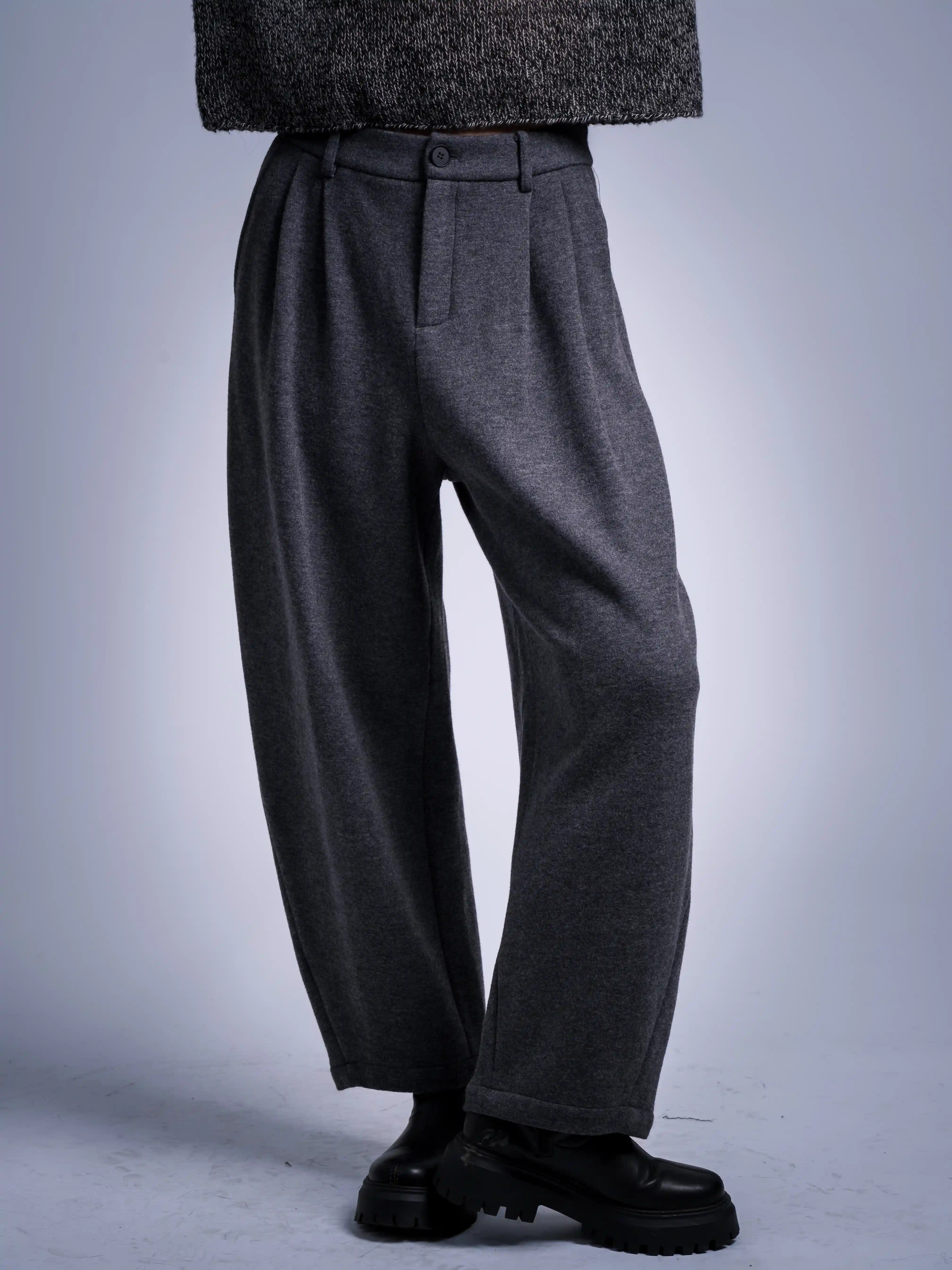 Grey wool blend trousers front view, relaxed tapered fit, soft drape, winter essential, styled with dark knit sweater.