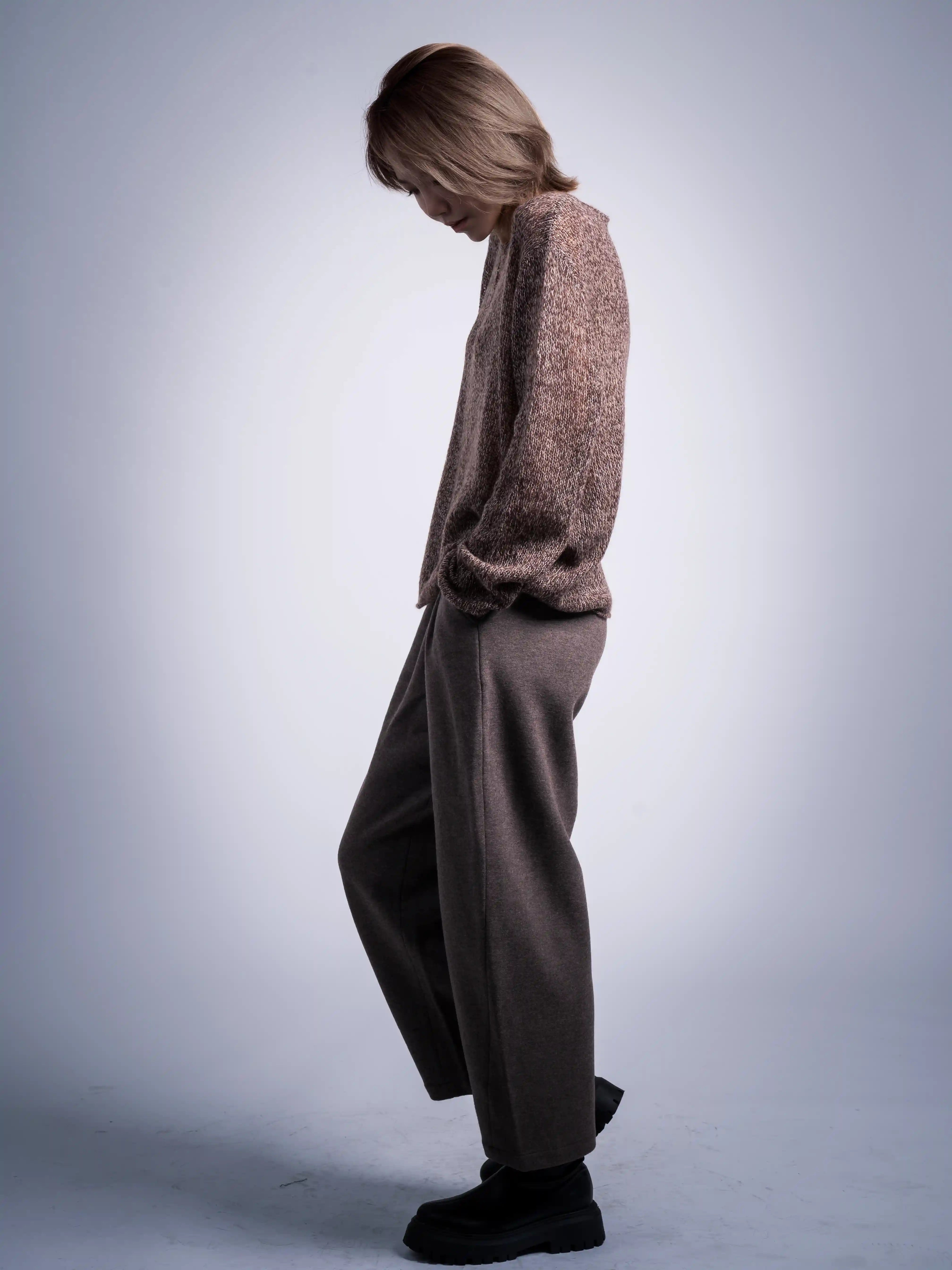 Full body side profile, grey wool trousers movement drape, effortless everyday winter look.