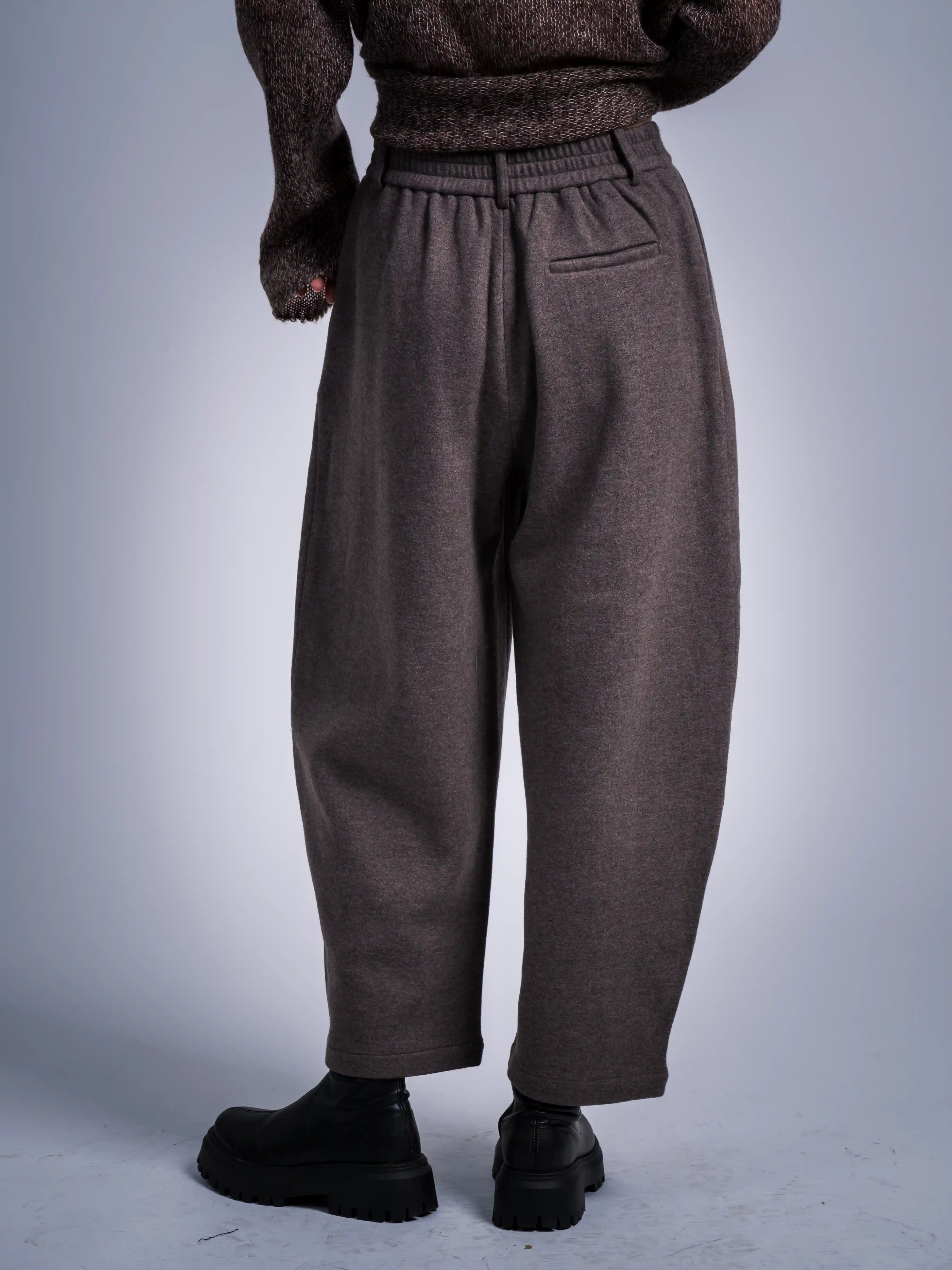 Brown knit with grey wool tapered trousers, clean waistline and cropped hem outfit view.