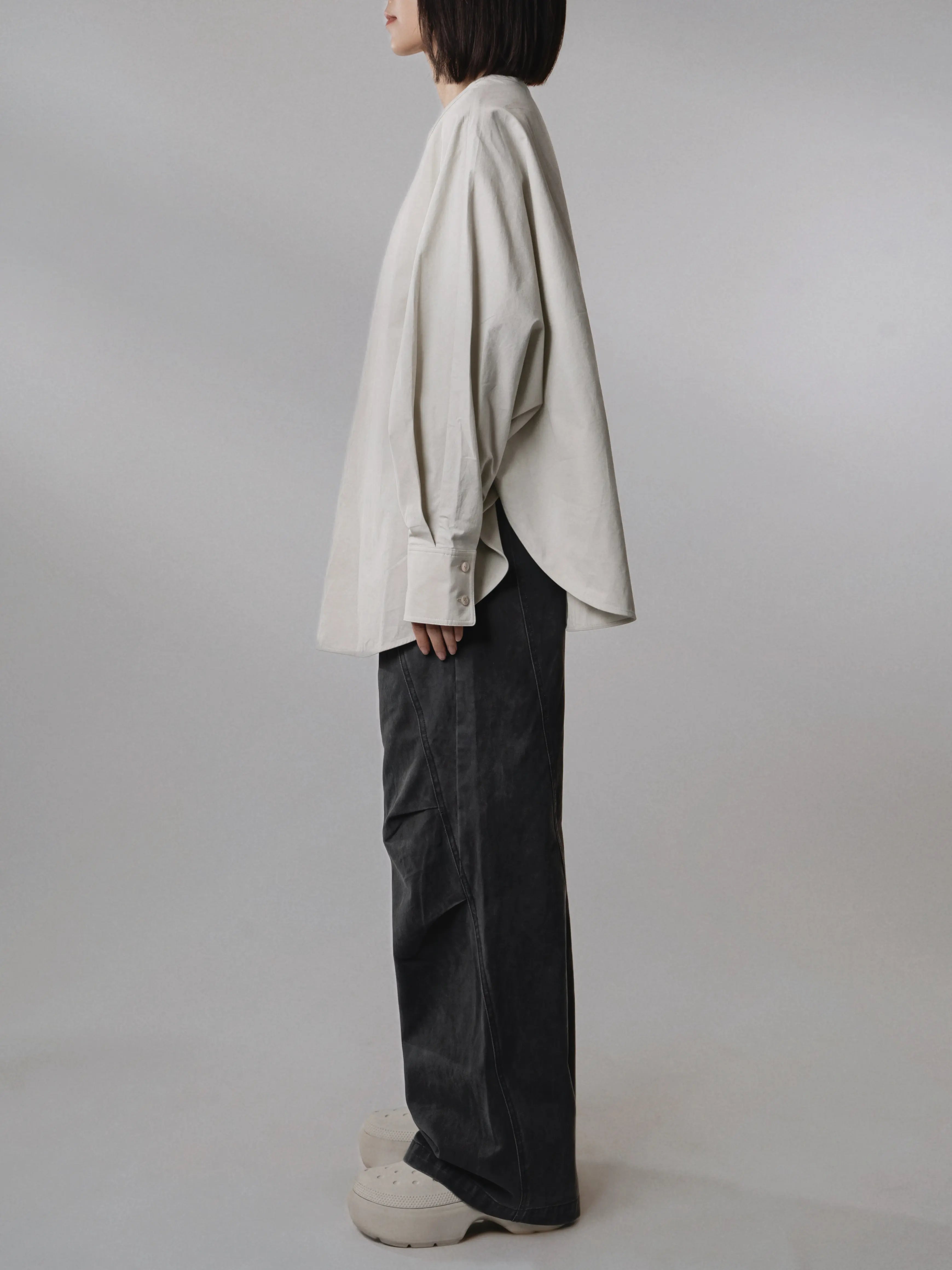 Side view of the Batwing Pullover in Muted Sage showcasing the oversized batwing silhouette.