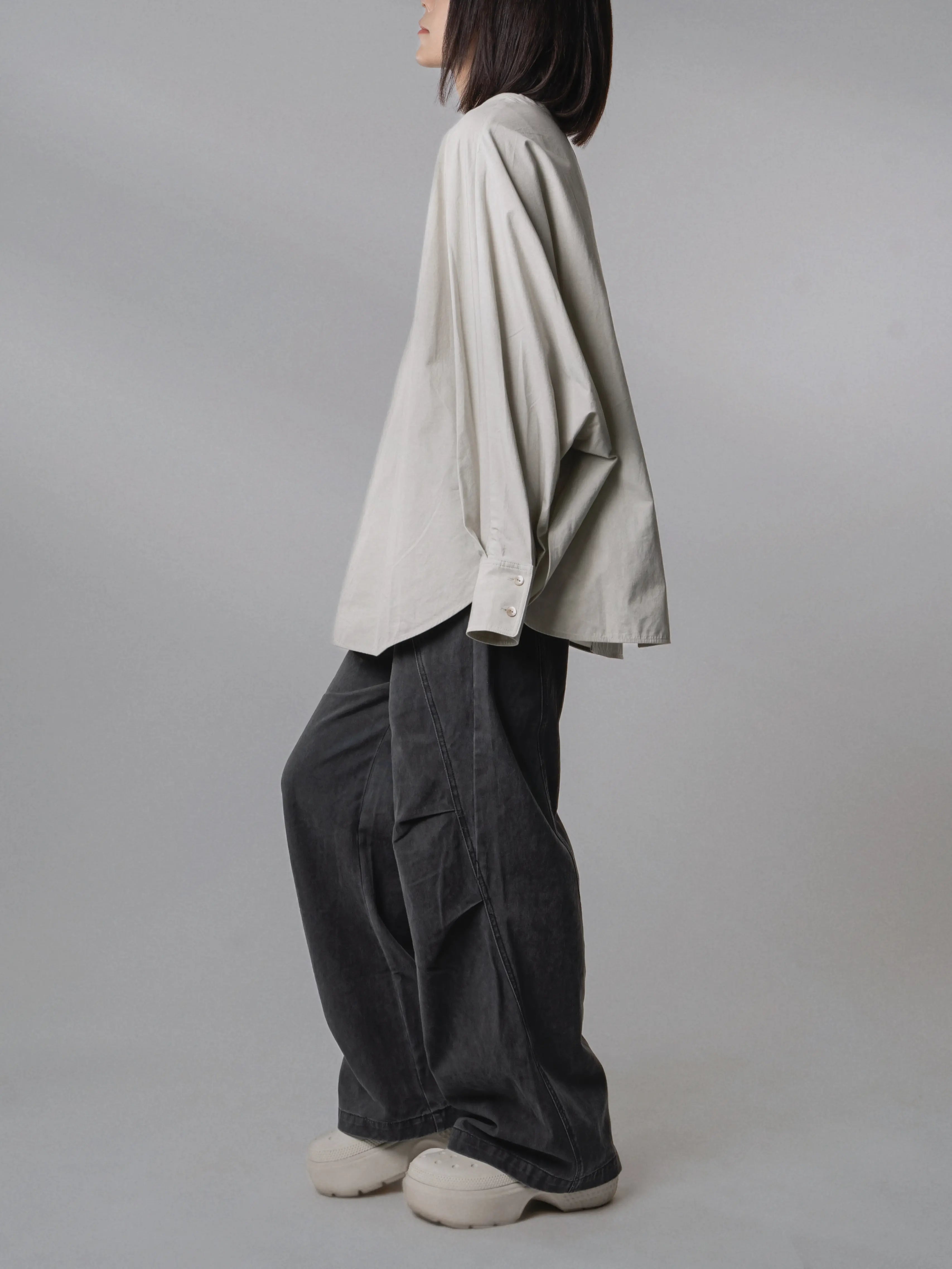 Three-quarter side view of the Batwing Pullover in Muted Sage highlighting the relaxed drape.