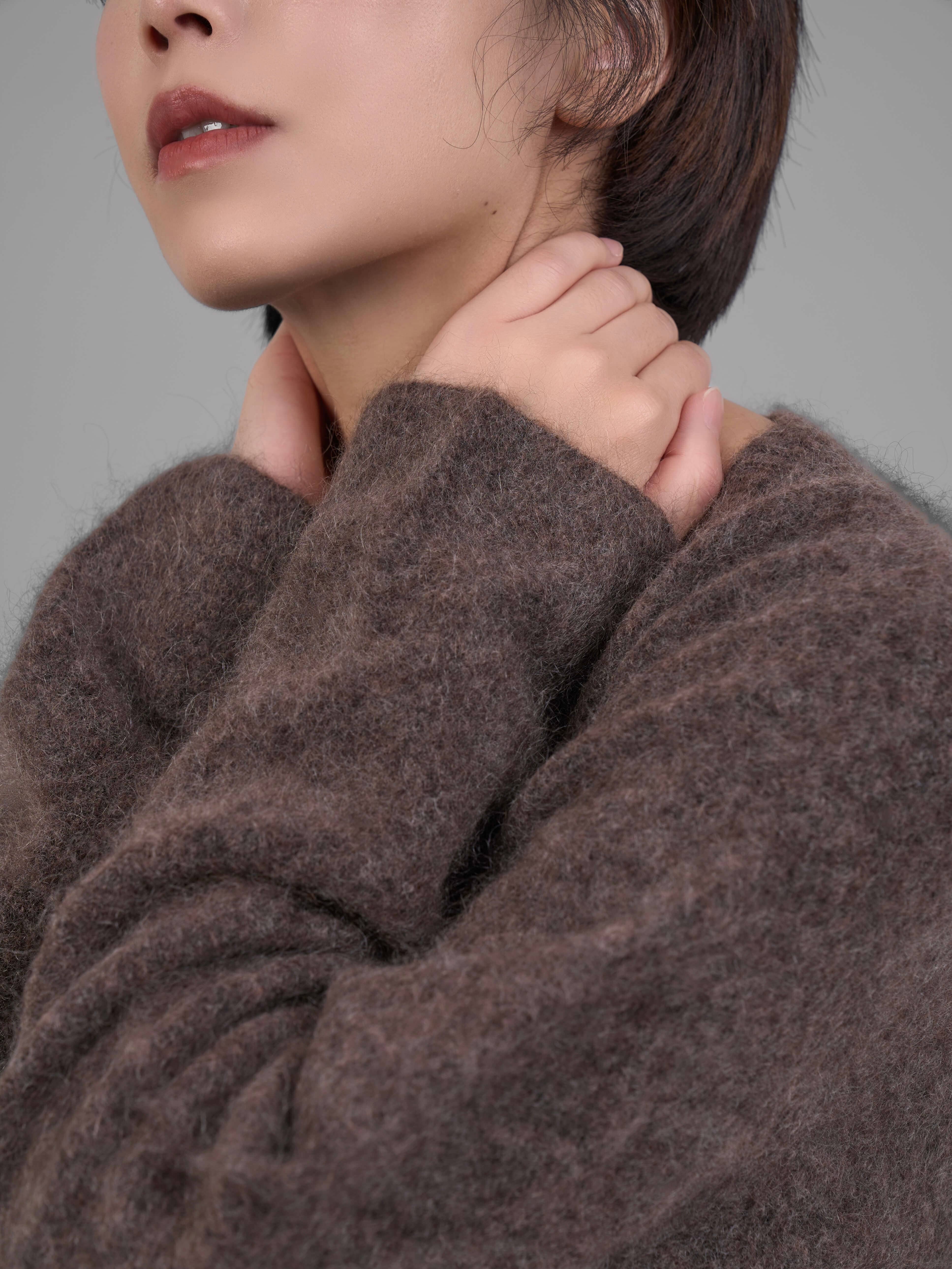 Brown V-neck mohair sweater fabric detail on sleeve and shoulder