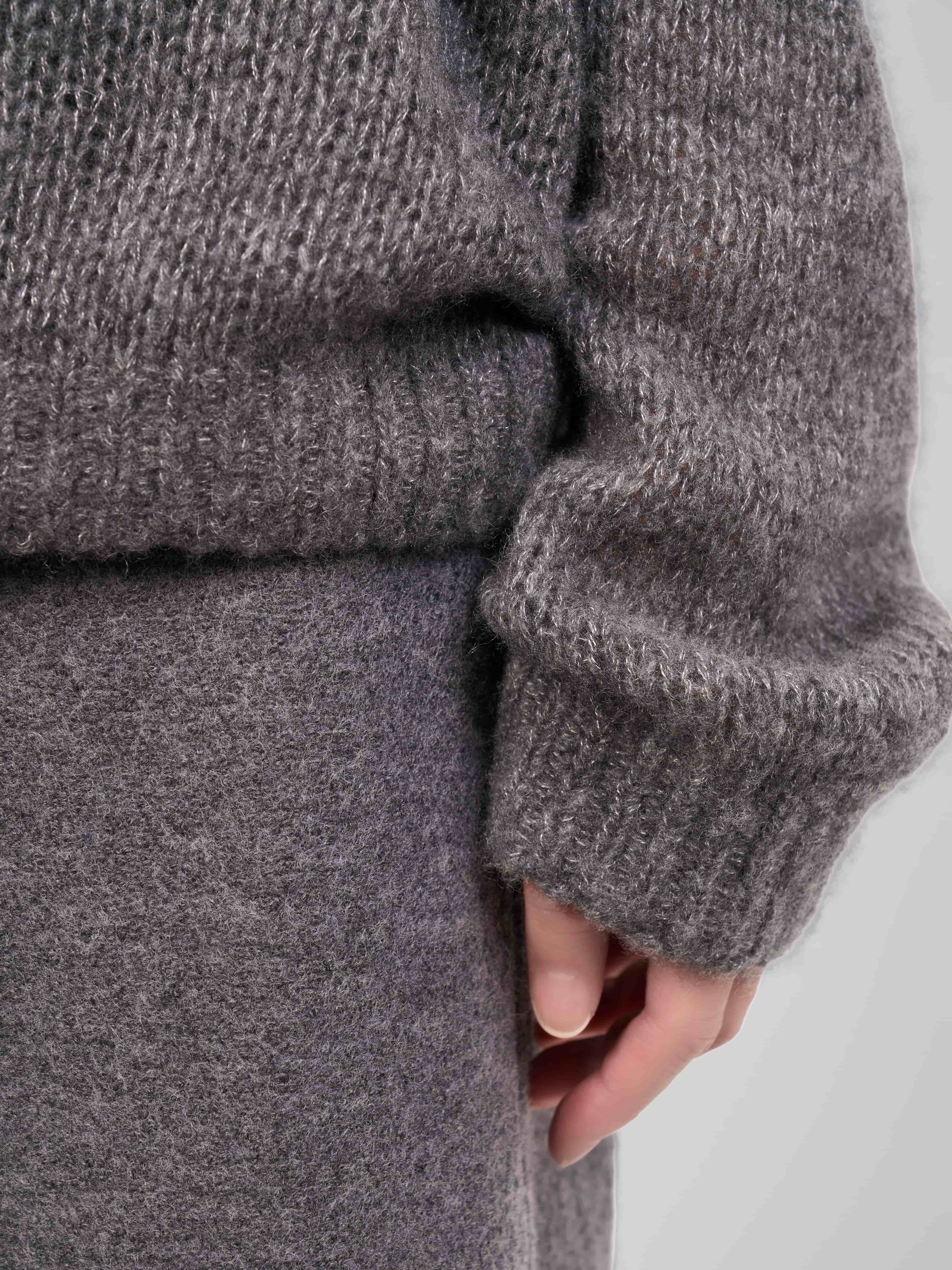 Side profile highlighting the sleeve and knit texture of the cashmere-silk sweater.