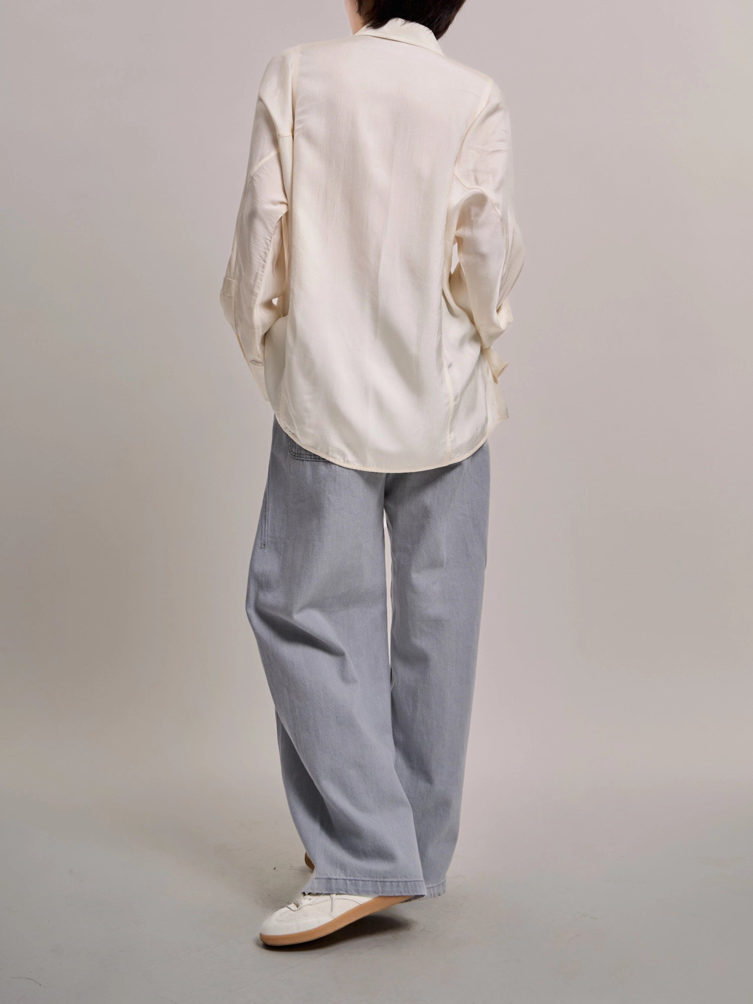 Back view of Curved Cocoon Jeans showing clean cocoon silhouette and relaxed volume.