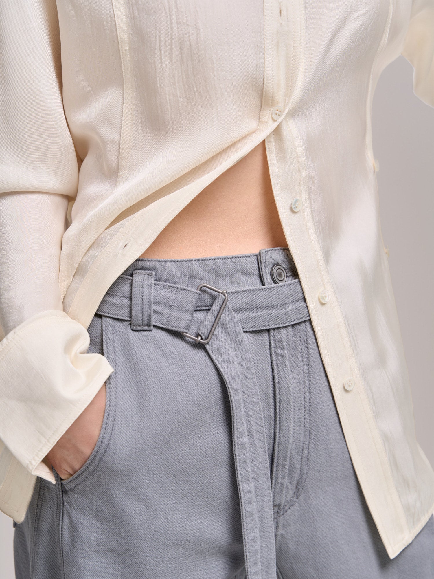 Waist and button detail of Curved Cocoon Jeans, showing clean construction and smooth blended lining.