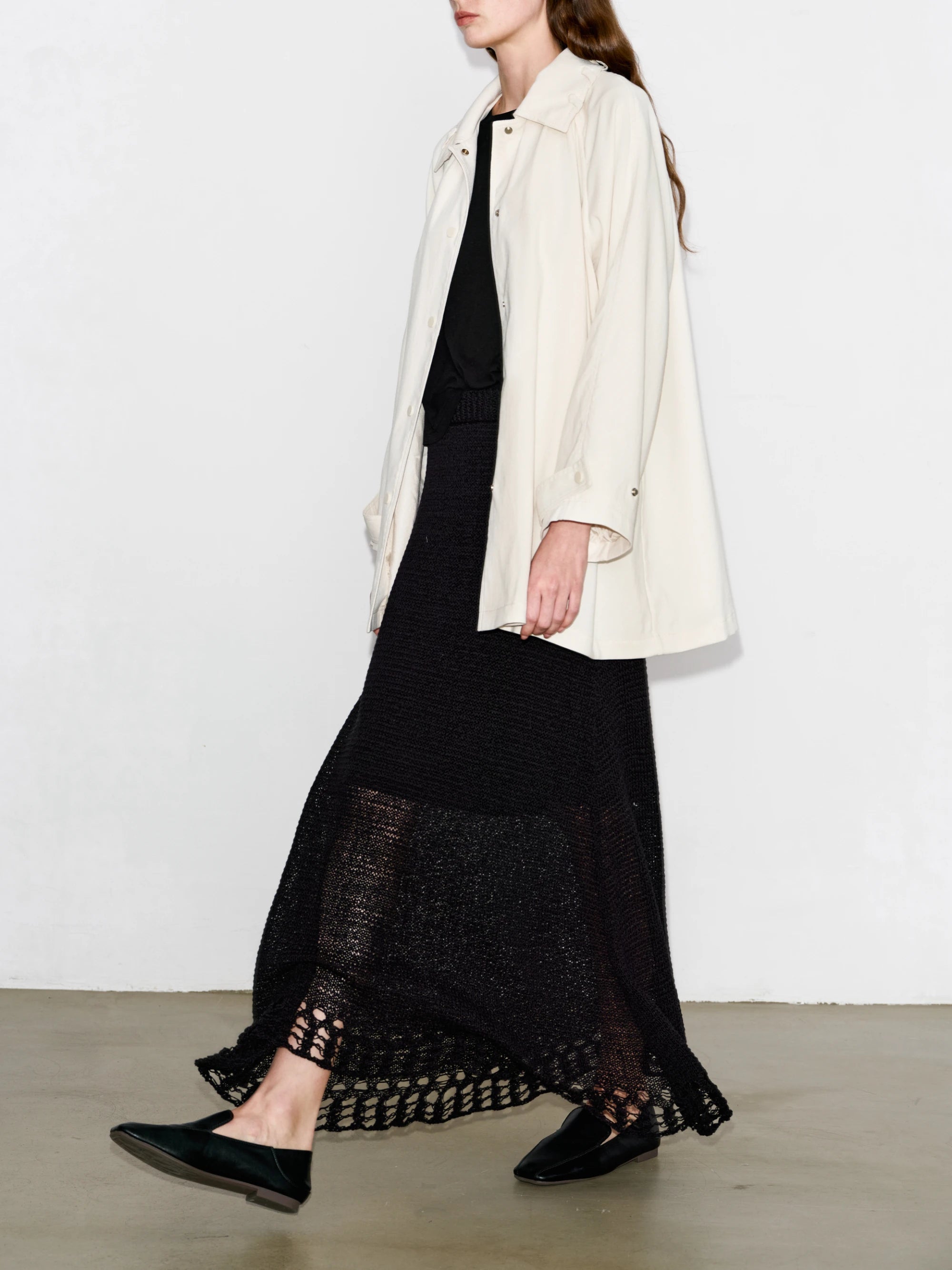 Side walking view of Drift Overshirt in ivory, lightweight flow, dropped shoulder silhouette.