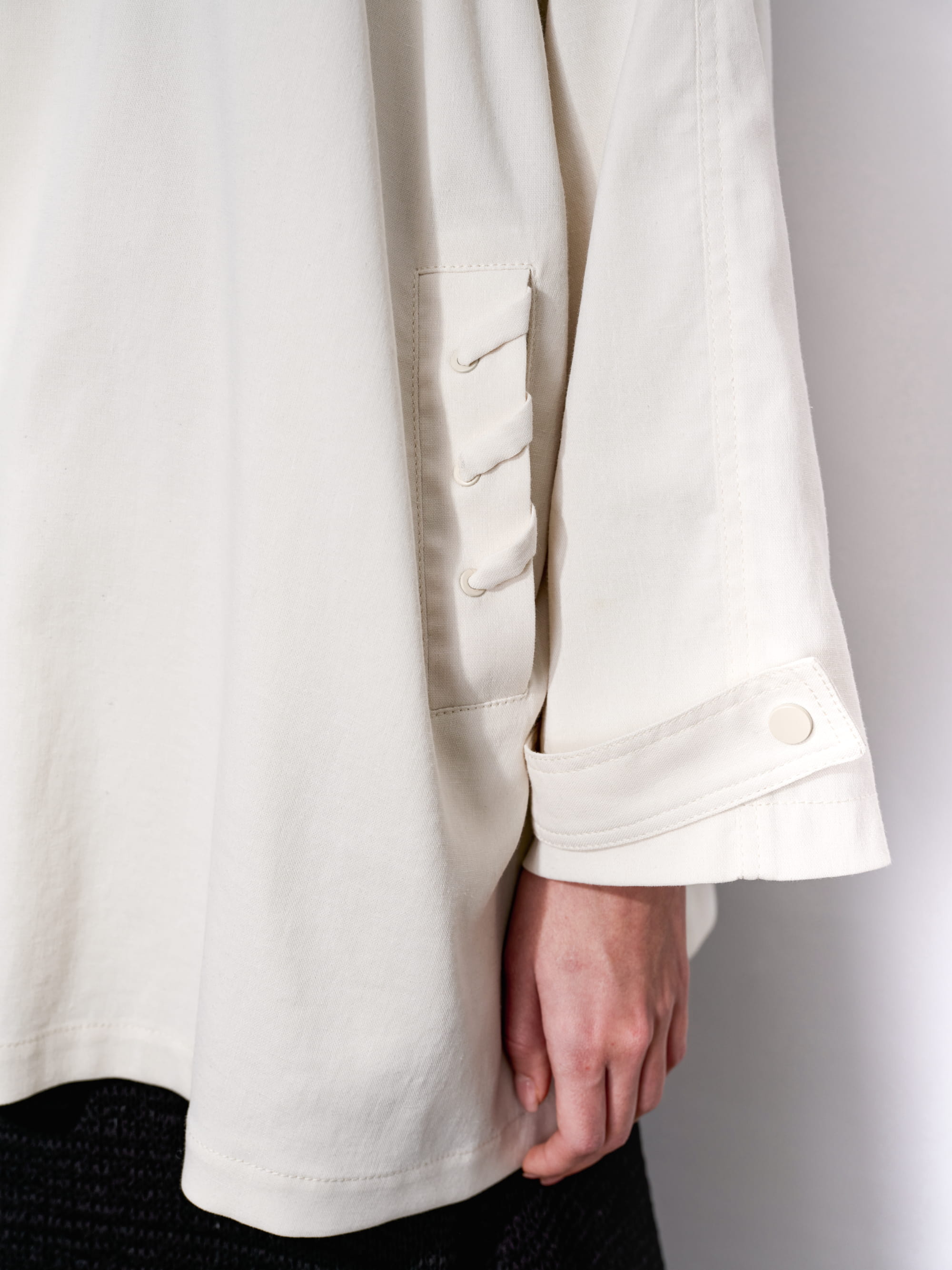 Sleeve detail crop showing wide cuff finishing and natural fabric drape of Drift Overshirt.