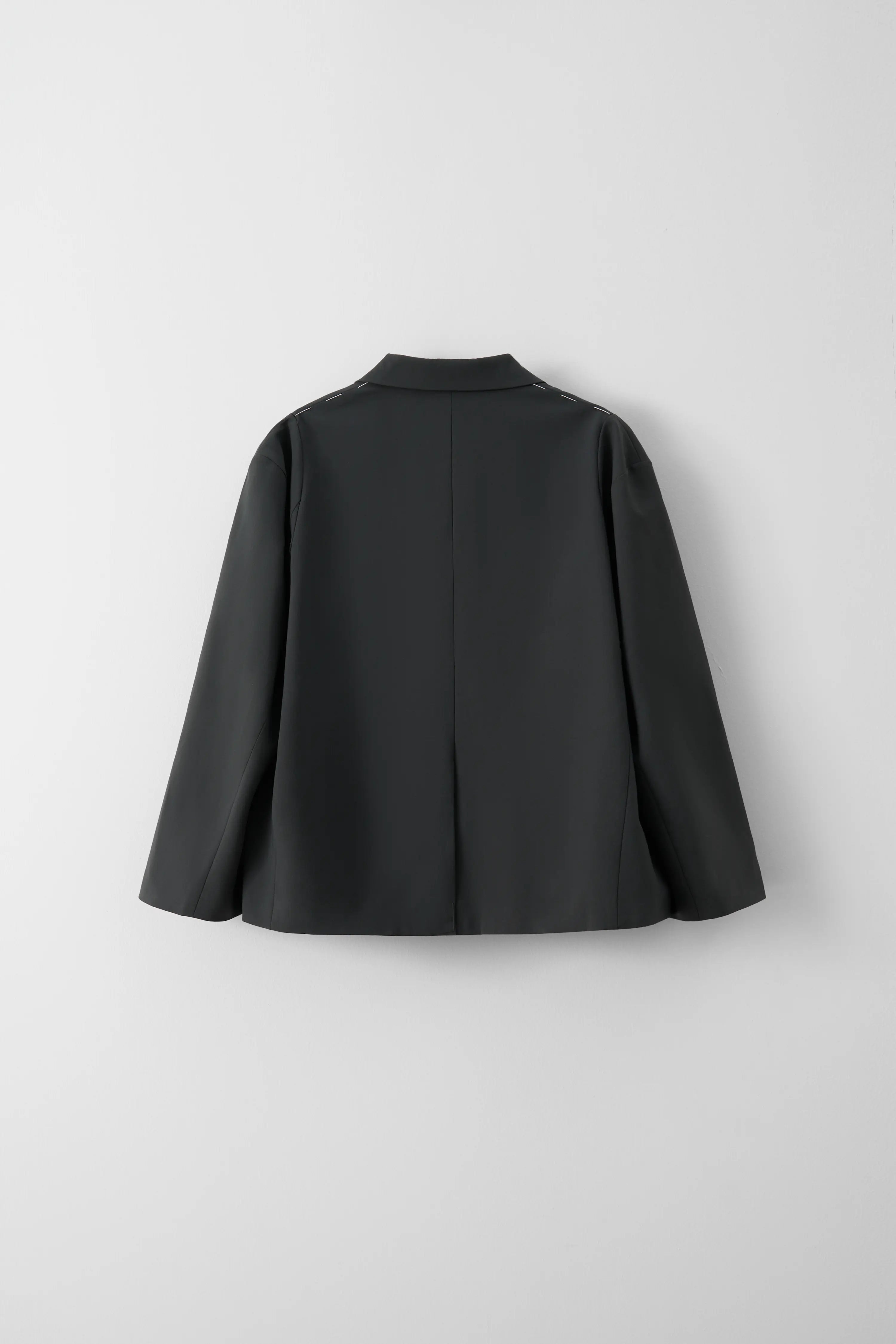 Back view showing the silhouette and dropped shoulder design of the charcoal blazer by XXL Smile.