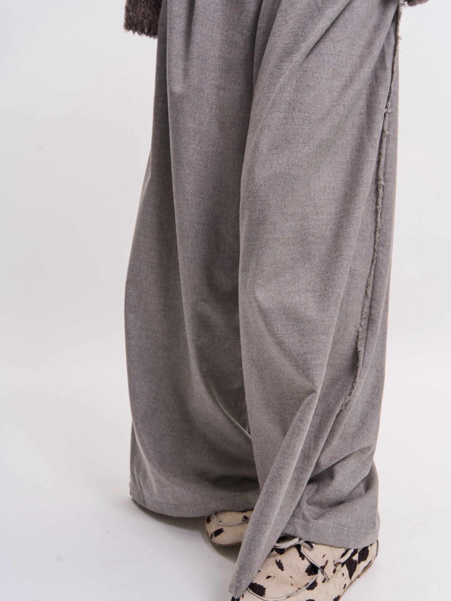 Hem and leg detail of grey Edge Wool Pants showing fluid drape and wide-leg movement.