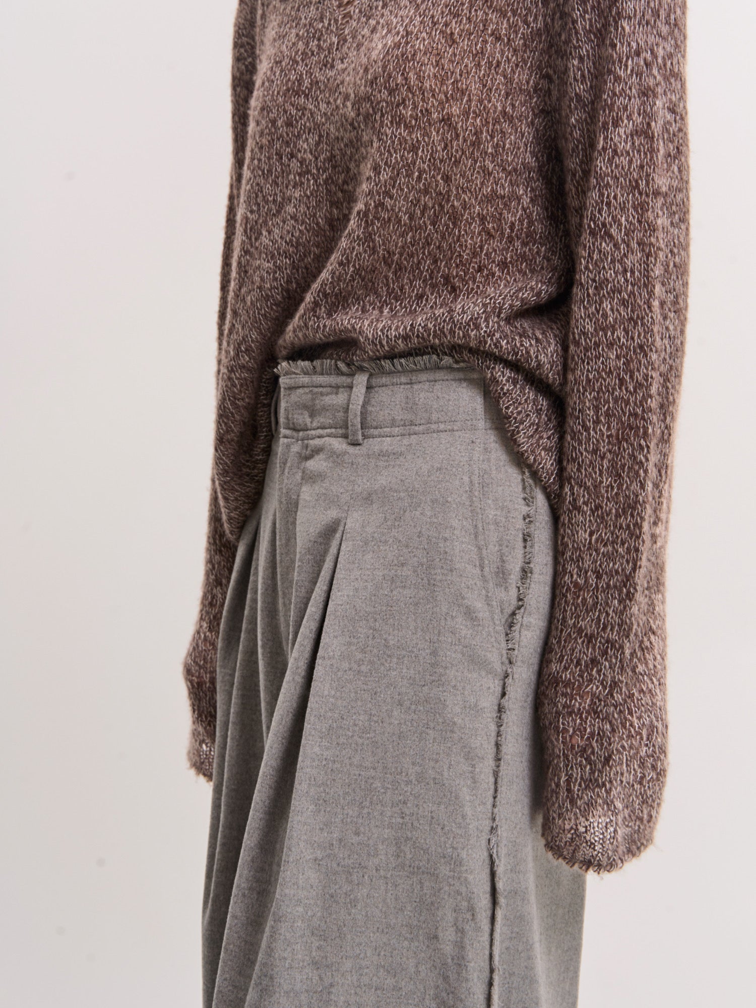 Side view of grey Edge Wool Pants highlighting smooth wool–modal blend and relaxed movement.