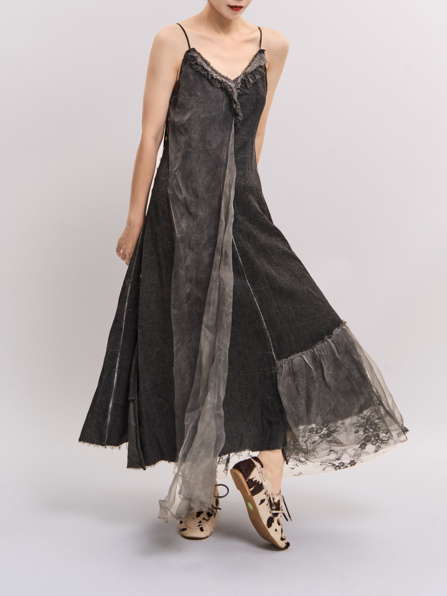 Back-angle movement shot of Mist Veil Dress highlighting fluid drape and asymmetric layered hem.