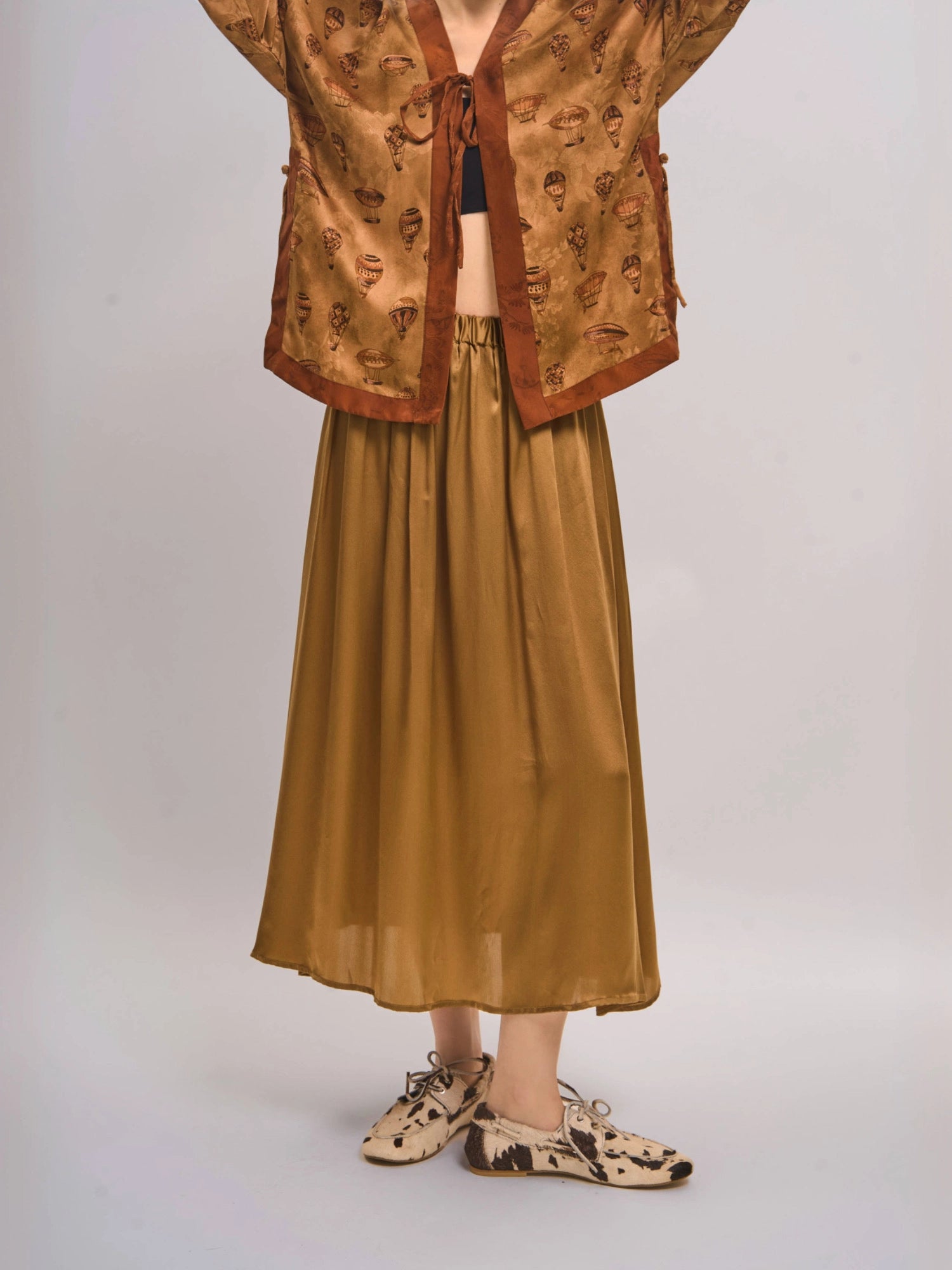 Side angle showing mulberry silk top layered over matching skirt, fluid coordinated look.