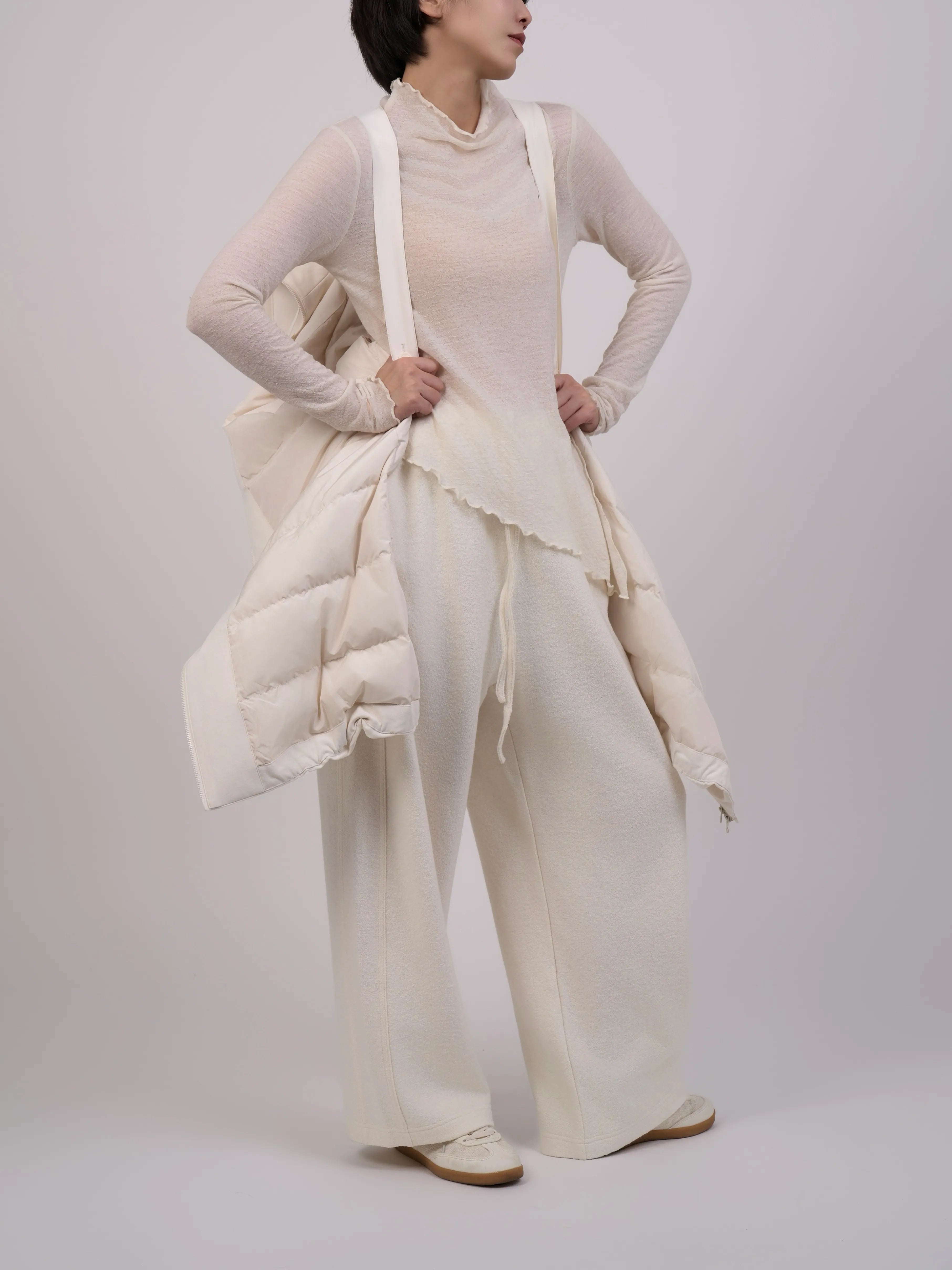 Model wearing Off-White Hooded Down Coat with hands in pockets highlighting practical winter styling.