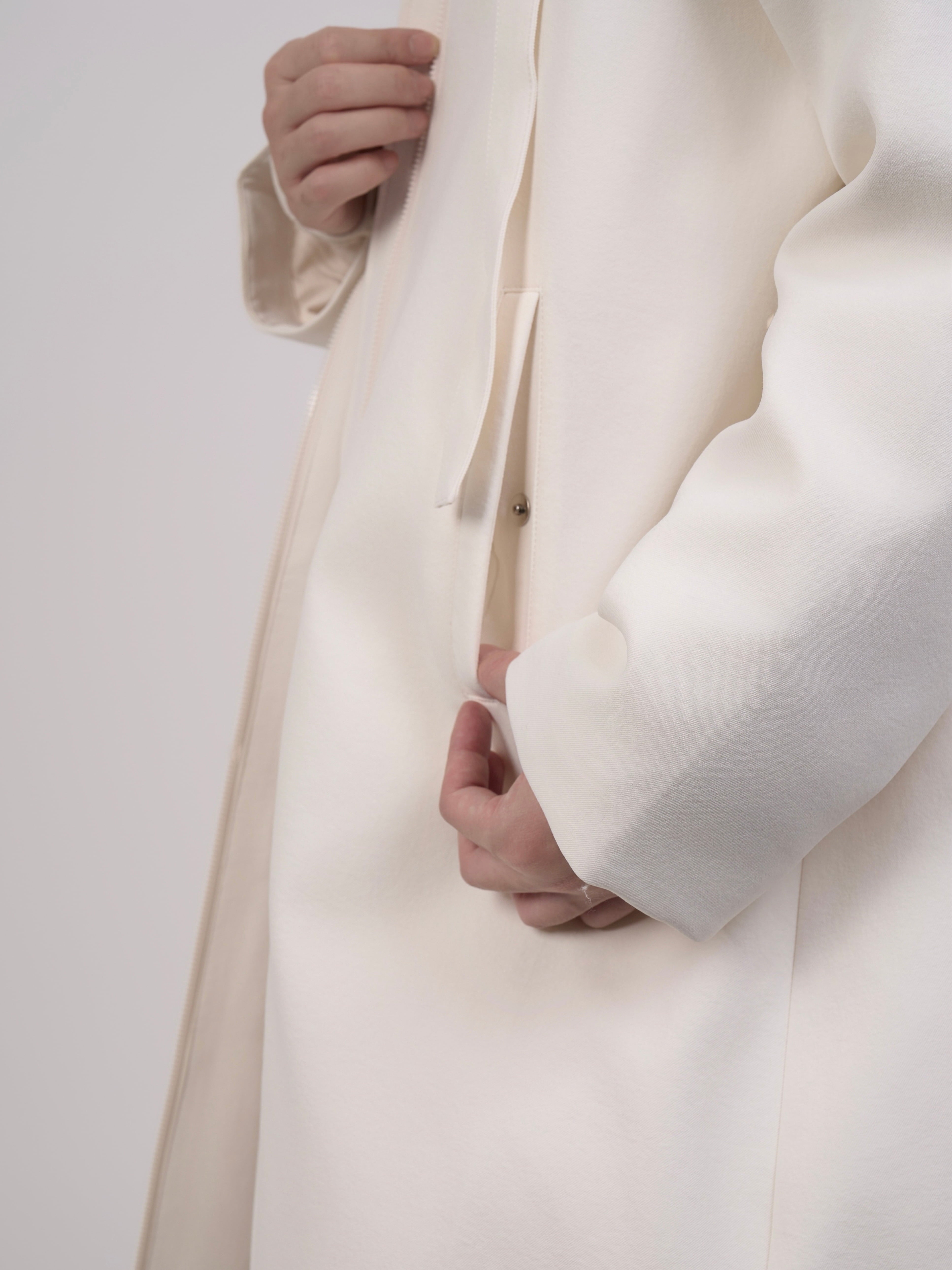 Close-up of Off-White Hooded Down Coat showing textured fabric and padding.