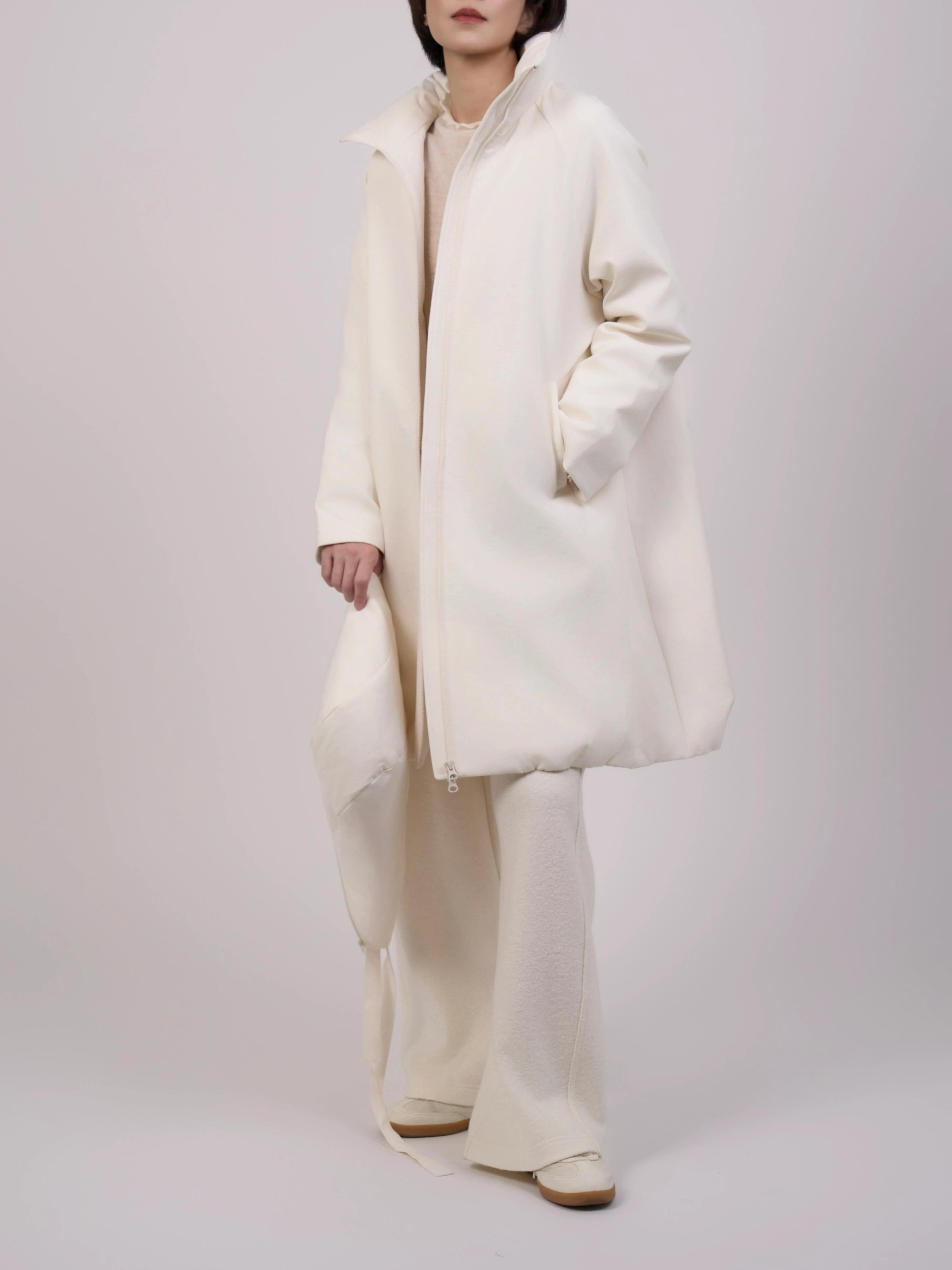 Three-quarter side pose of Off-White Hooded Down Coat emphasizing flow and soft structure.
