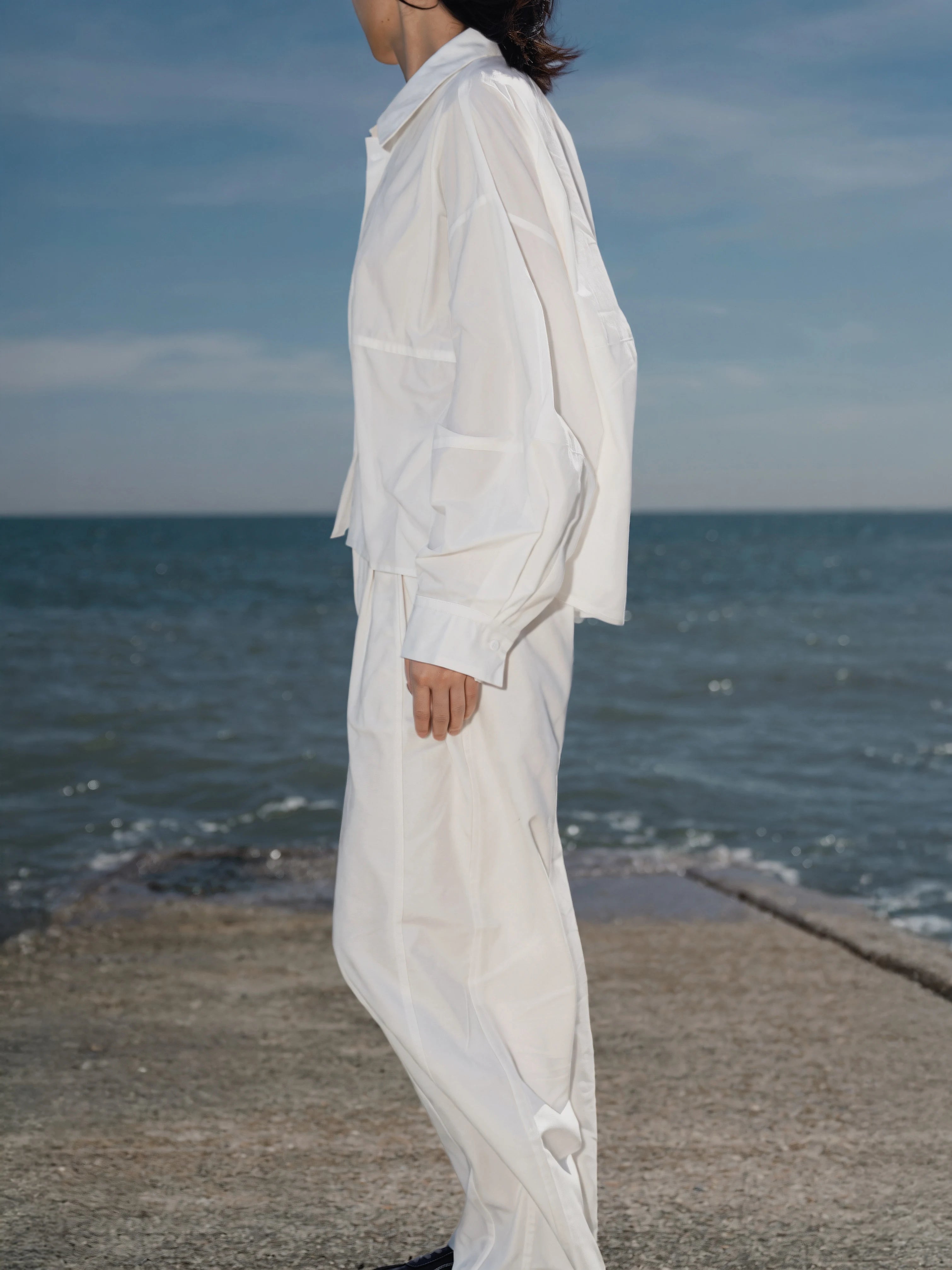 Close-up of the Pima Boxy Shirt in Soft Cream highlighting the relaxed collar and clean silhouette.