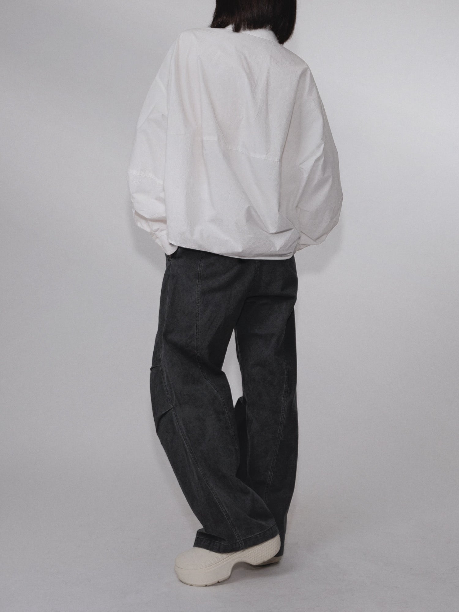 Back-side view of the Pima Boxy Shirt in Soft Cream showing the oversized drape.