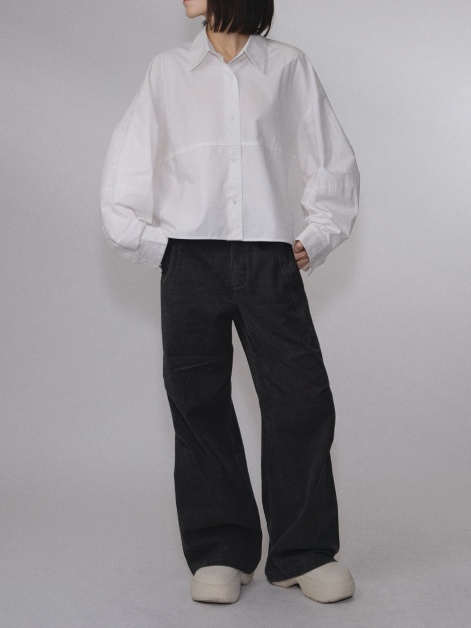 Front view of the Pima Boxy Shirt in Soft Cream paired with relaxed wide-leg trousers.
