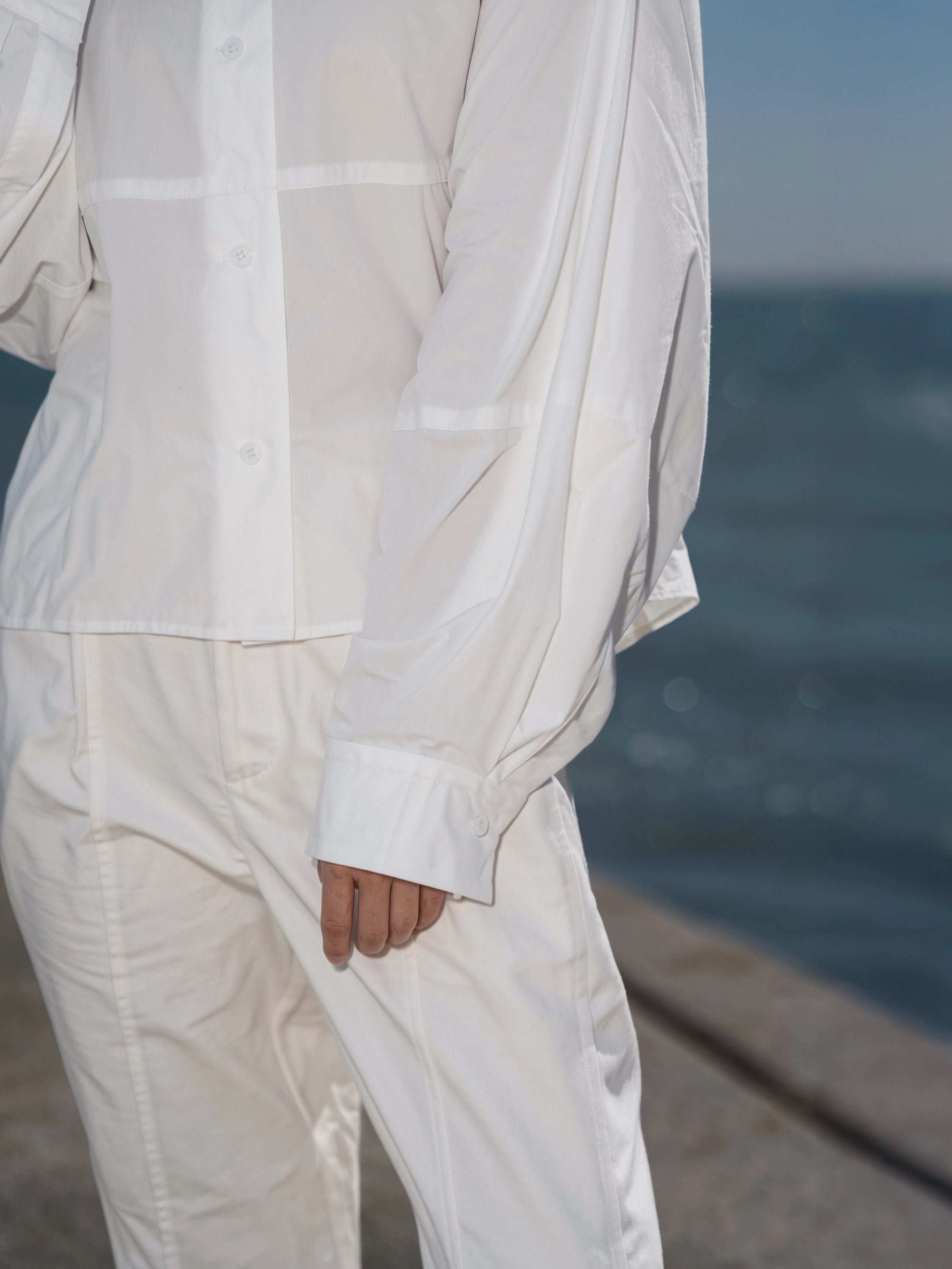 Front view of the Pima Boxy Shirt in Soft Cream paired with relaxed wide-leg trousers.