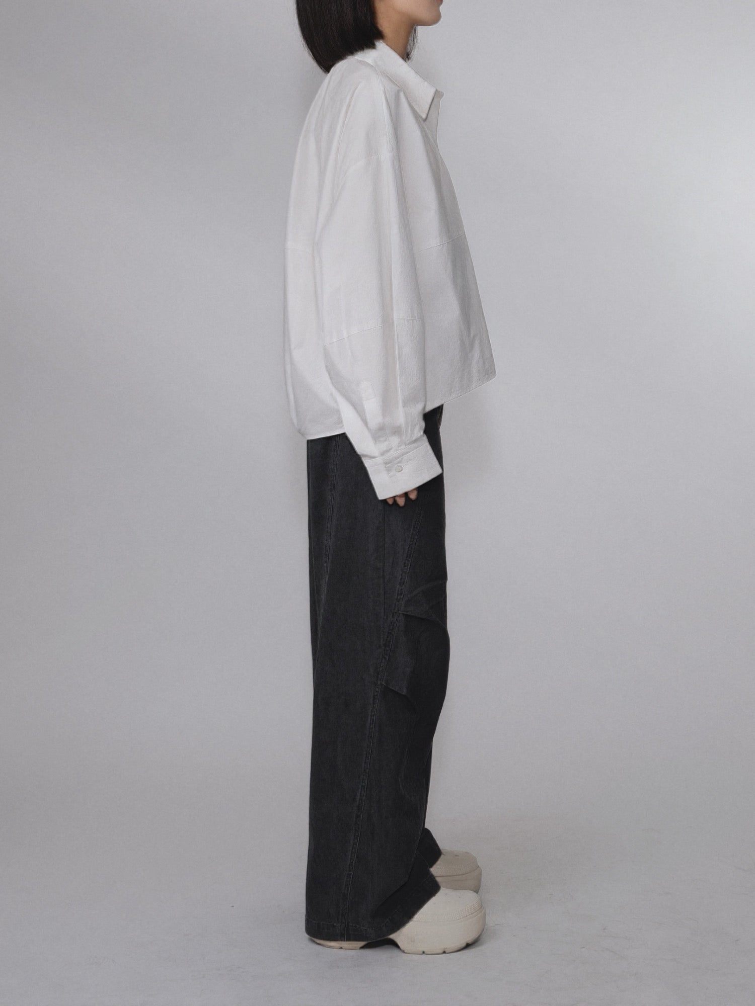Side view of the Pima Boxy Shirt in Soft Cream showing the boxy silhouette.