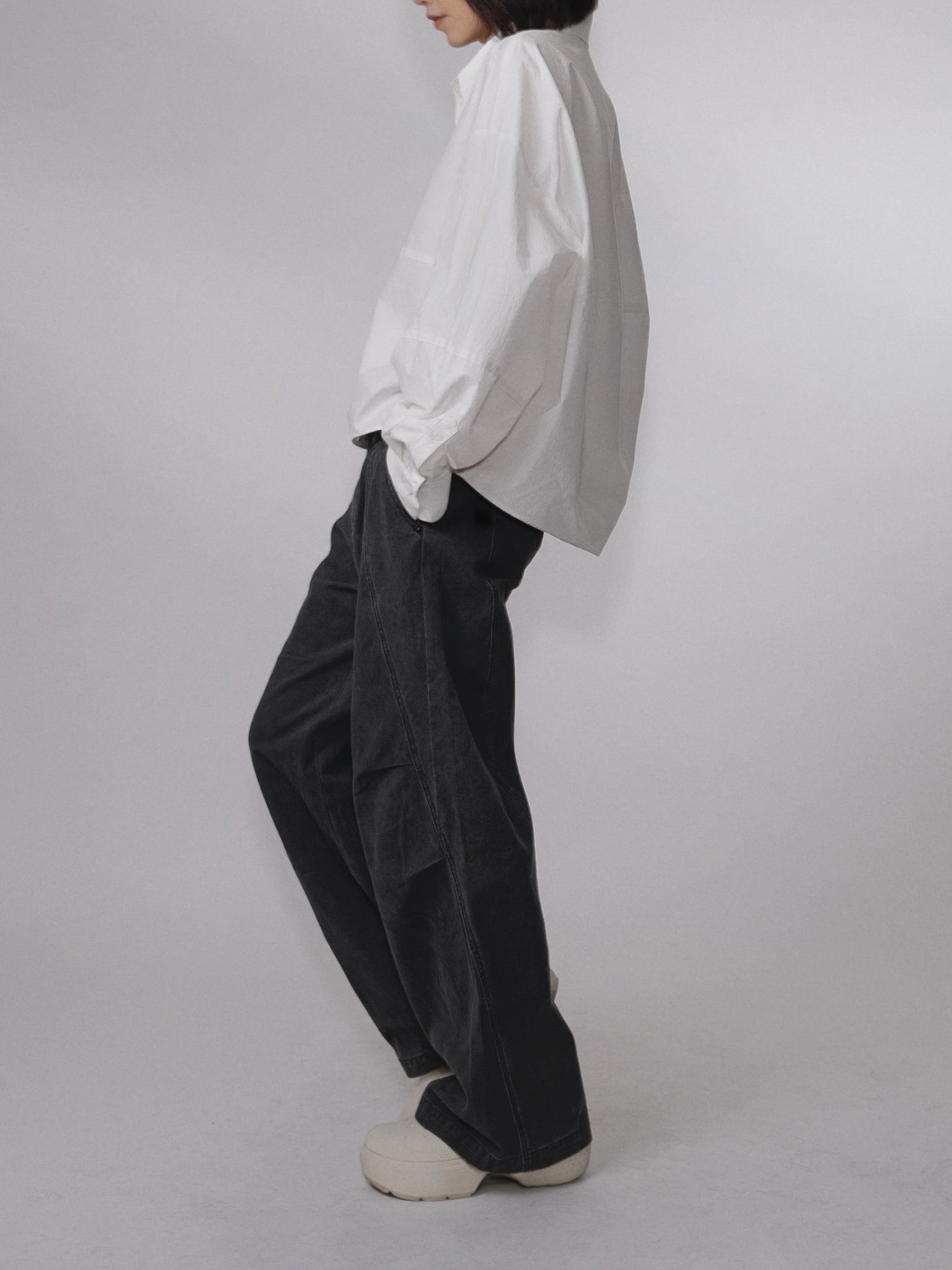 Three-quarter side view of the Pima Boxy Shirt in Soft Cream with an oversized fit.