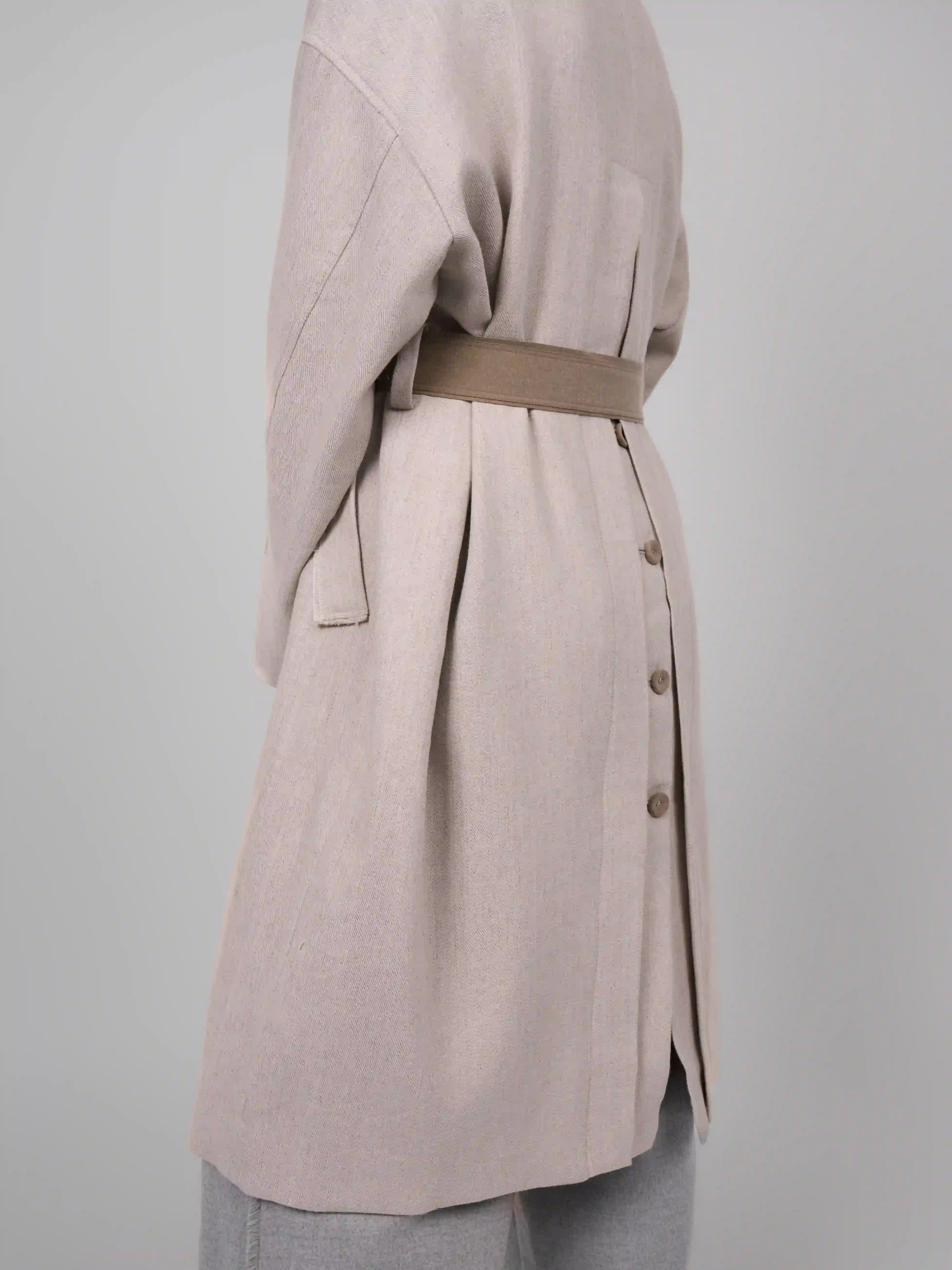 Back waist detail of rain dew linen wool coat by XXLsmile showing button line and tailored drape