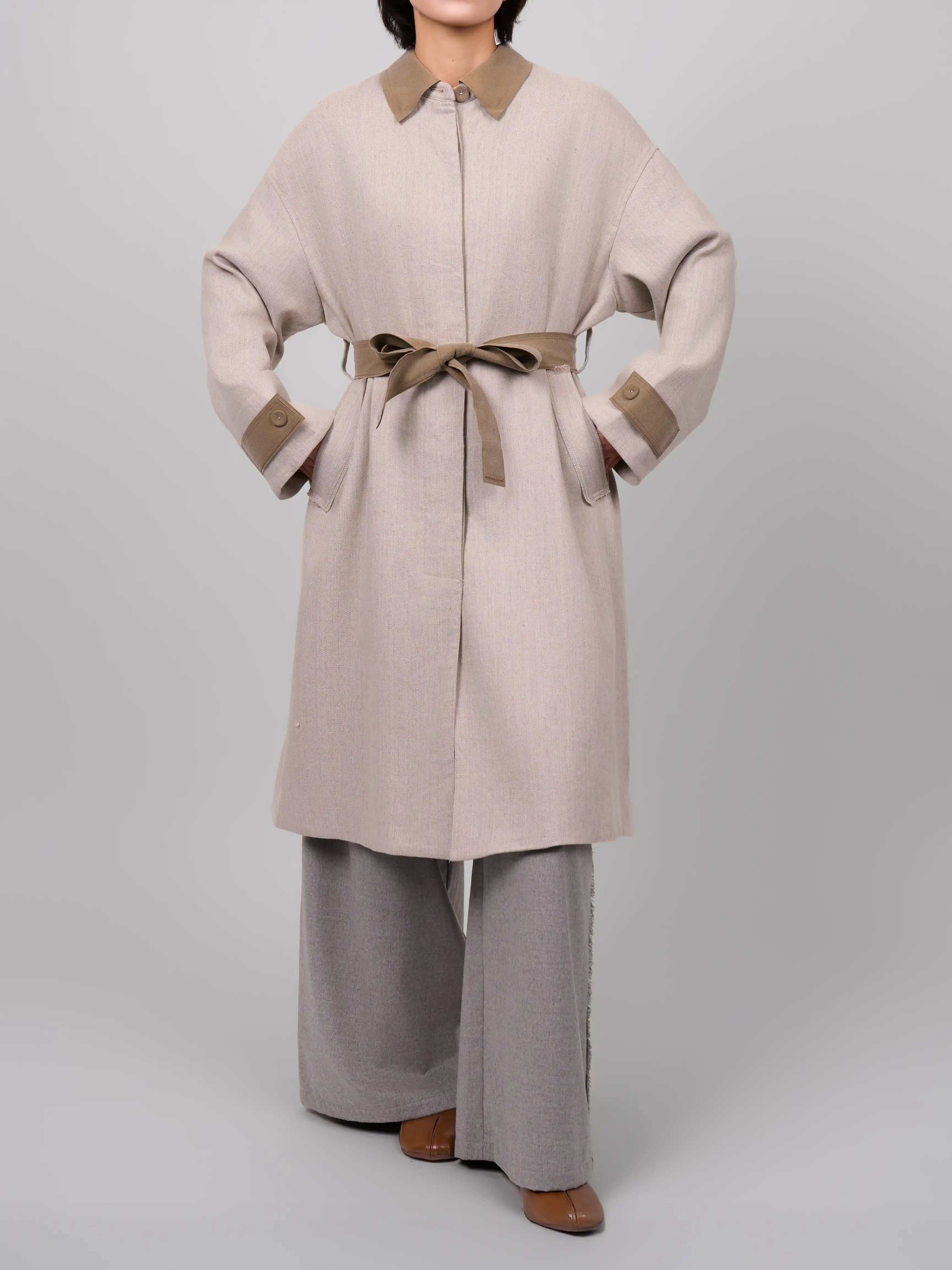 Front full body view of XXLsmile rain dew linen wool coat in beige with tied belt and minimalist oversized design
