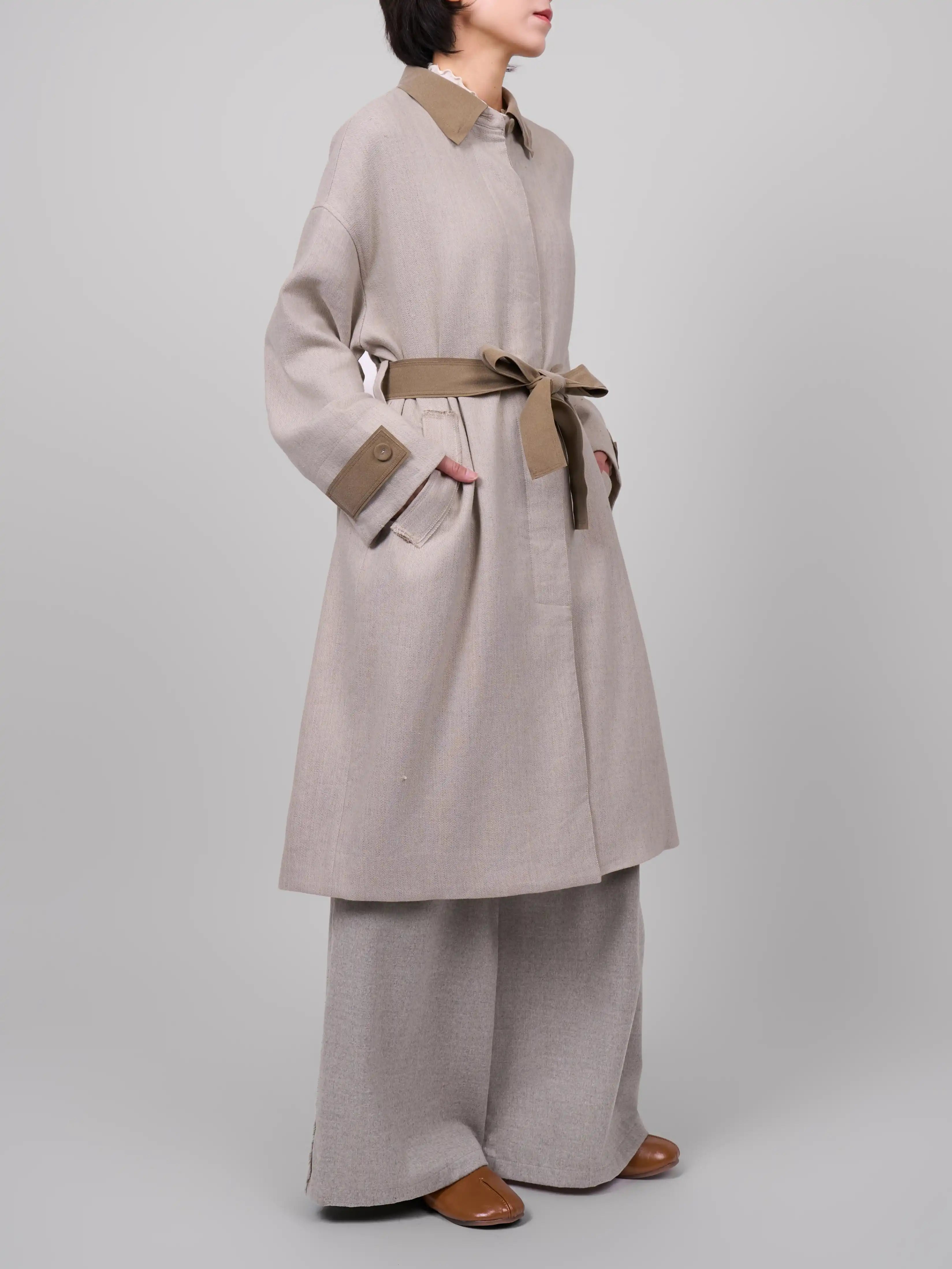 Side belted silhouette of XXLsmile beige linen wool coat highlighting waist shape and modern tailoring